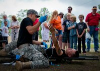Spc. Kyle Kraft performs a combat medical demonstration during the 6th Ranger Training Battalion’s Open House event May 10 at Eglin Air Force Base, Fla.  The event was a chance for the public to learn how Rangers train and operate. The event displays showed equipment, weapons, a reptile zoo, face painting and weapon firing among others. The demonstrations showed off hand-to-hand combat, a parachute jump, snake show, and Rangers in action.  (U.S. Air Force photo/Tech. Sgt. Sam King)