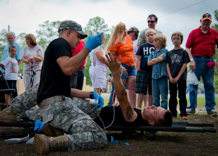 Spc. Kyle Kraft performs a combat medical demonstration during the 6th Ranger Training Battalion’s Open House event May 10 at Eglin Air Force Base, Fla.  The event was a chance for the public to learn how Rangers train and operate. The event displays showed equipment, weapons, a reptile zoo, face painting and weapon firing among others. The demonstrations showed off hand-to-hand combat, a parachute jump, snake show, and Rangers in action.  (U.S. Air Force photo/Tech. Sgt. Sam King)