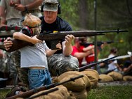 With a little Army support, a “soldier in training” aims his rifle downrange during the 6th Ranger Training Battalion’s Open House event May 10 at Eglin Air Force Base, Fla.  The event was a chance for the public to learn how Rangers train and operate. The event displays showed equipment, weapons, a reptile zoo, face painting and weapon firing among others. The demonstrations showed off hand-to-hand combat, a parachute jump, snake show, and Rangers in action.  (U.S. Air Force photo/Tech. Sgt. Sam King)