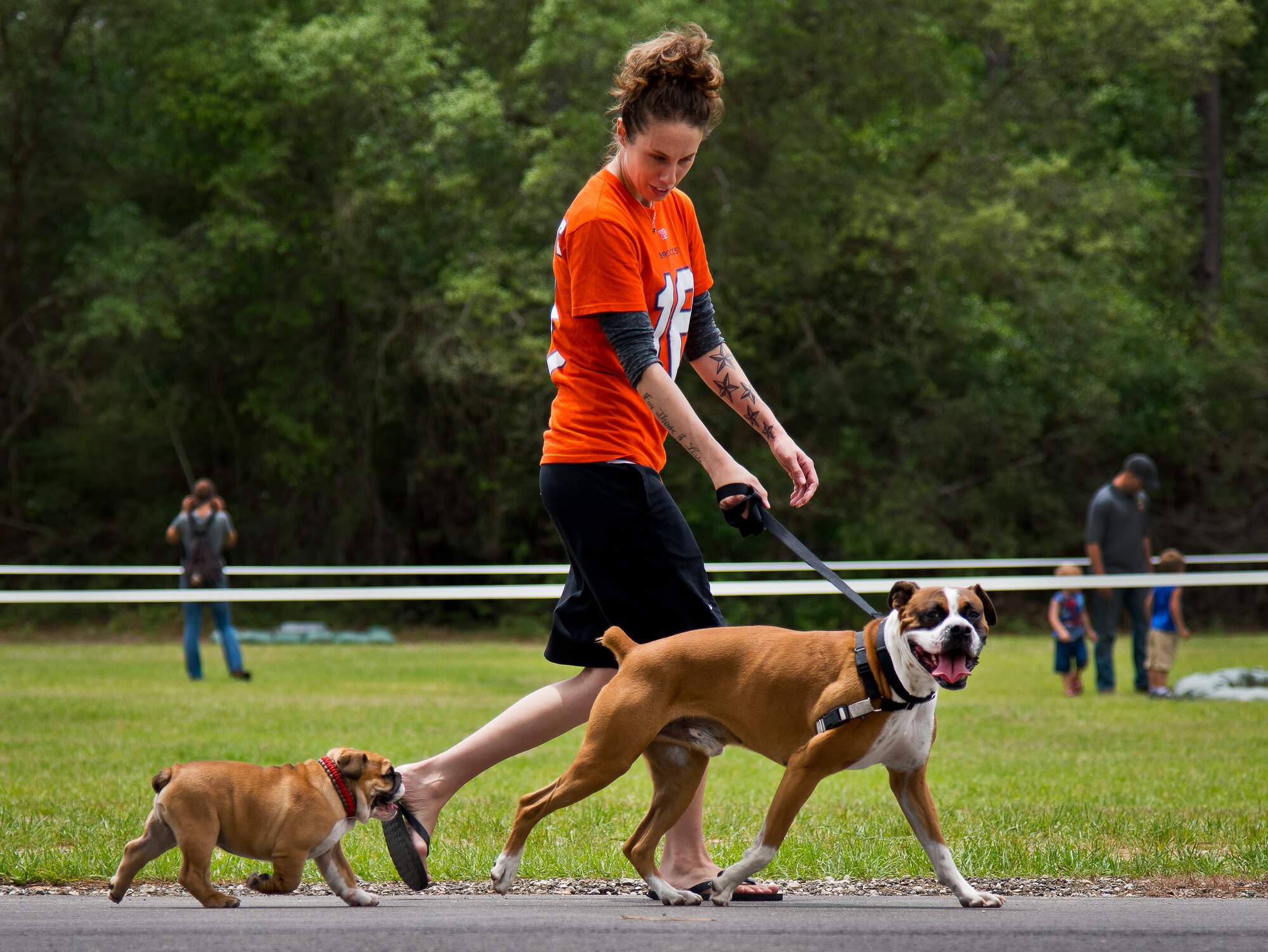 A 6th Ranger Training Battalion Open House attendee walks her bulldogs May 10 at Eglin Air Force Base, Fla.  (U.S. Air Force photo/Tech. Sgt. Sam King)