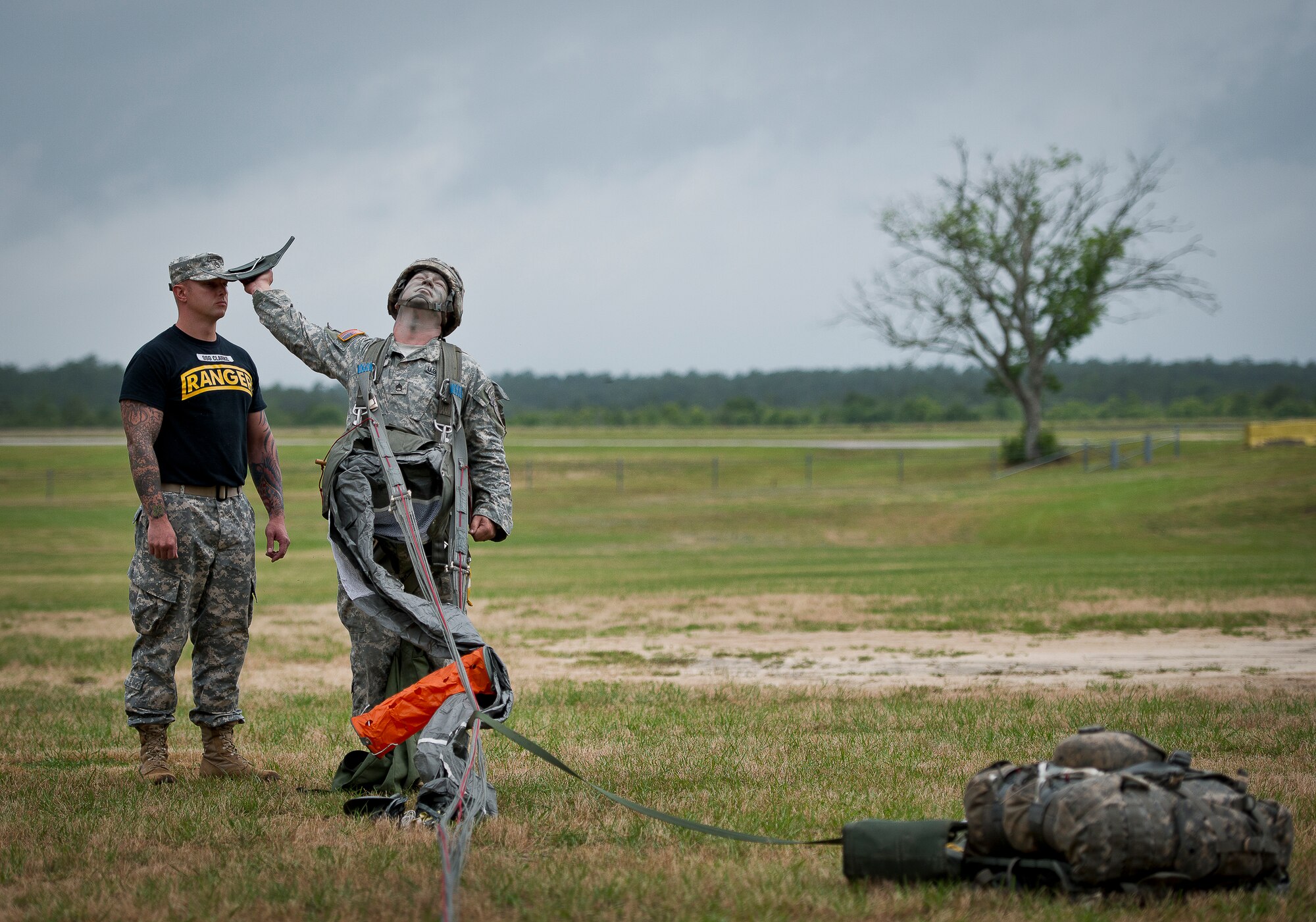 A Ranger demonstrates parachute jump procedures during a demonstration at the 6th Ranger Training Battalion’s Open House event May 10 at Eglin Air Force Base, Fla.  The event was a chance for the public to learn how Rangers train and operate. The event displays showed equipment, weapons, a reptile zoo, face painting and weapon firing among others. The demonstrations showed off hand-to-hand combat, a parachute jump, snake show, and Rangers in action.  (U.S. Air Force photo/Tech. Sgt. Sam King)