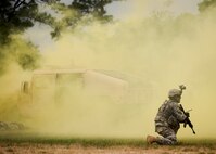 A Ranger surveys the scene and shouts orders to team members during a demonstration at the 6th Ranger Training Battalion’s Open House event May 10 at Eglin Air Force Base, Fla.  The event was a chance for the public to learn how Rangers train and operate. The event displays showed equipment, weapons, a reptile zoo, face painting and weapon firing among others. The demonstrations showed off hand-to-hand combat, a parachute jump, snake show, and Rangers in action.  (U.S. Air Force photo/Tech. Sgt. Sam King)