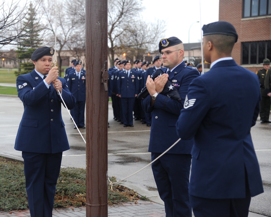 Members of the 319th Security Forces Squadron conduct a reveille ceremony to begin National Police Week May 12, 2014, on Grand Forks Air Force Base, N.D. National Police Week is a series of events to memorialize law enforcement officers who have made the ultimate sacrifice. (U.S. Air Force photo/Senior Airman Zachiah Roberson)