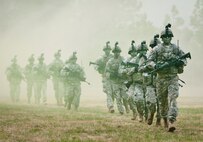 A team of Rangers enters the field through smoke during a demonstration at the 6th Ranger Training Battalion’s Open House event May 10 at Eglin Air Force Base, Fla.  The event was a chance for the public to learn how Rangers train and operate. The event displays showed equipment, weapons, a reptile zoo, face painting and weapon firing among others. The demonstrations showed off hand-to-hand combat, a parachute jump, snake show, and Rangers in action.  (U.S. Air Force photo/Tech. Sgt. Sam King)