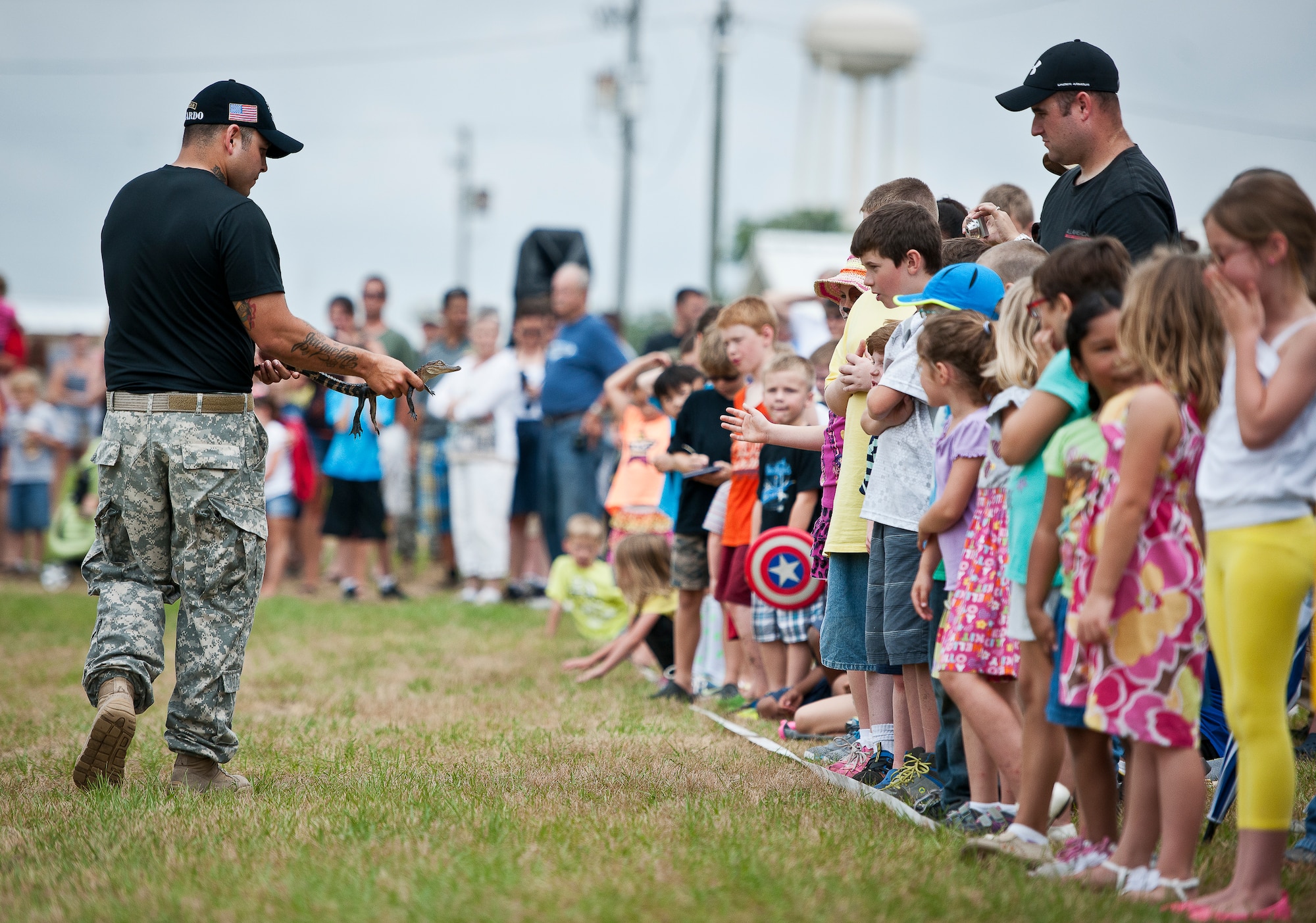 A Soldier with the 6th Ranger Training Battalion shows a baby alligator to the audience at the Rangers’ Open House event May 10 at Eglin Air Force Base, Fla.  The event was a chance for the public to learn how Rangers train and operate. The event displays showed equipment, weapons, a reptile zoo, face painting and weapon firing among others. The demonstrations showed off hand-to-hand combat, a parachute jump, snake show, and Rangers in action.  (U.S. Air Force photo/Tech. Sgt. Sam King)