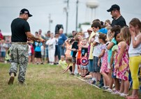 A Soldier with the 6th Ranger Training Battalion shows a baby alligator to the audience at the Rangers’ Open House event May 10 at Eglin Air Force Base, Fla.  The event was a chance for the public to learn how Rangers train and operate. The event displays showed equipment, weapons, a reptile zoo, face painting and weapon firing among others. The demonstrations showed off hand-to-hand combat, a parachute jump, snake show, and Rangers in action.  (U.S. Air Force photo/Tech. Sgt. Sam King)