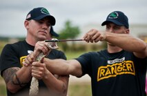 The 6th Ranger Training Battalion’s resident snake handlers show the fangs of poisonous snake to the crowd during the snake show demonstration at the Rangers’ Open House event May 10 at Eglin Air Force Base, Fla.  The event was a chance for the public to learn how Rangers train and operate. The event displays showed equipment, weapons, a reptile zoo, face painting and weapon firing among others. The demonstrations showed off hand-to-hand combat, a parachute jump, snake show, and Rangers in action.  (U.S. Air Force photo/Tech. Sgt. Sam King