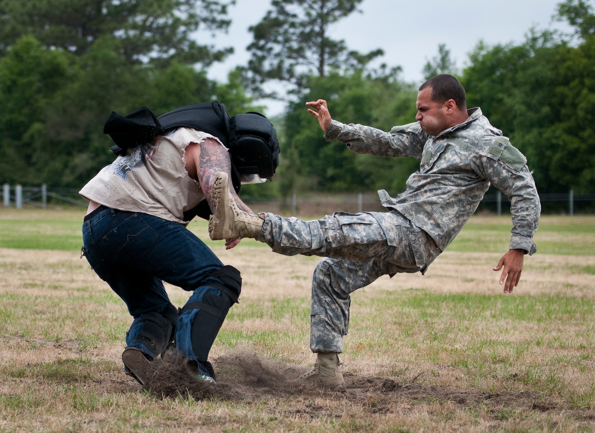 Staff Sgt. Ariel Rivera performs a kick on a rowdy “audience member” during the hand-to-hand combat demonstration at the 6th Ranger Training Battalion’s Open House event May 10 at Eglin Air Force Base, Fla.  The event was a chance for the public to learn how Rangers train and operate. The event displays showed equipment, weapons, a reptile zoo, face painting and weapon firing among others. The demonstrations showed off hand-to-hand combat, a parachute jump, snake show, and Rangers in action.  (U.S. Air Force photo/Tech. Sgt. Sam King)