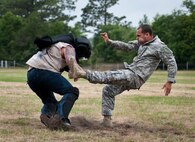 Staff Sgt. Ariel Rivera performs a kick on a rowdy “audience member” during the hand-to-hand combat demonstration at the 6th Ranger Training Battalion’s Open House event May 10 at Eglin Air Force Base, Fla.  The event was a chance for the public to learn how Rangers train and operate. The event displays showed equipment, weapons, a reptile zoo, face painting and weapon firing among others. The demonstrations showed off hand-to-hand combat, a parachute jump, snake show, and Rangers in action.  (U.S. Air Force photo/Tech. Sgt. Sam King)