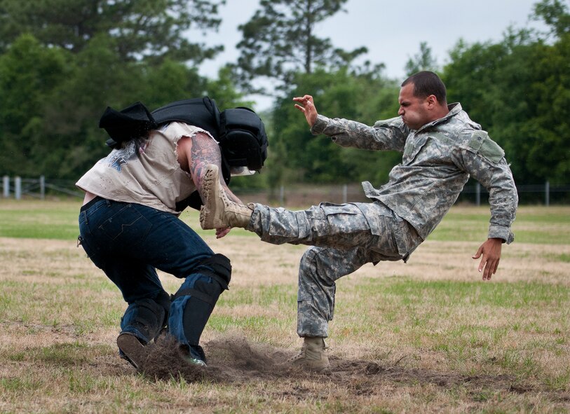 Staff Sgt. Ariel Rivera performs a kick on a rowdy “audience member” during the hand-to-hand combat demonstration at the 6th Ranger Training Battalion’s Open House event May 10 at Eglin Air Force Base, Fla.  The event was a chance for the public to learn how Rangers train and operate. The event displays showed equipment, weapons, a reptile zoo, face painting and weapon firing among others. The demonstrations showed off hand-to-hand combat, a parachute jump, snake show, and Rangers in action.  (U.S. Air Force photo/Tech. Sgt. Sam King)
