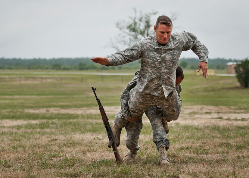 Staff Sgt. Ariel Rivera tackles Sgt. 1st Class Christian Bearden from behind during the hand-to-hand combat demonstration at the 6th Ranger Training Battalion’s Open House event May 10 at Eglin Air Force Base, Fla.  The event was a chance for the public to learn how Rangers train and operate. The event displays showed equipment, weapons, a reptile zoo, face painting and weapon firing among others. The demonstrations showed off hand-to-hand combat, a parachute jump, snake show, and Rangers in action.  (U.S. Air Force photo/Tech. Sgt. Sam King)