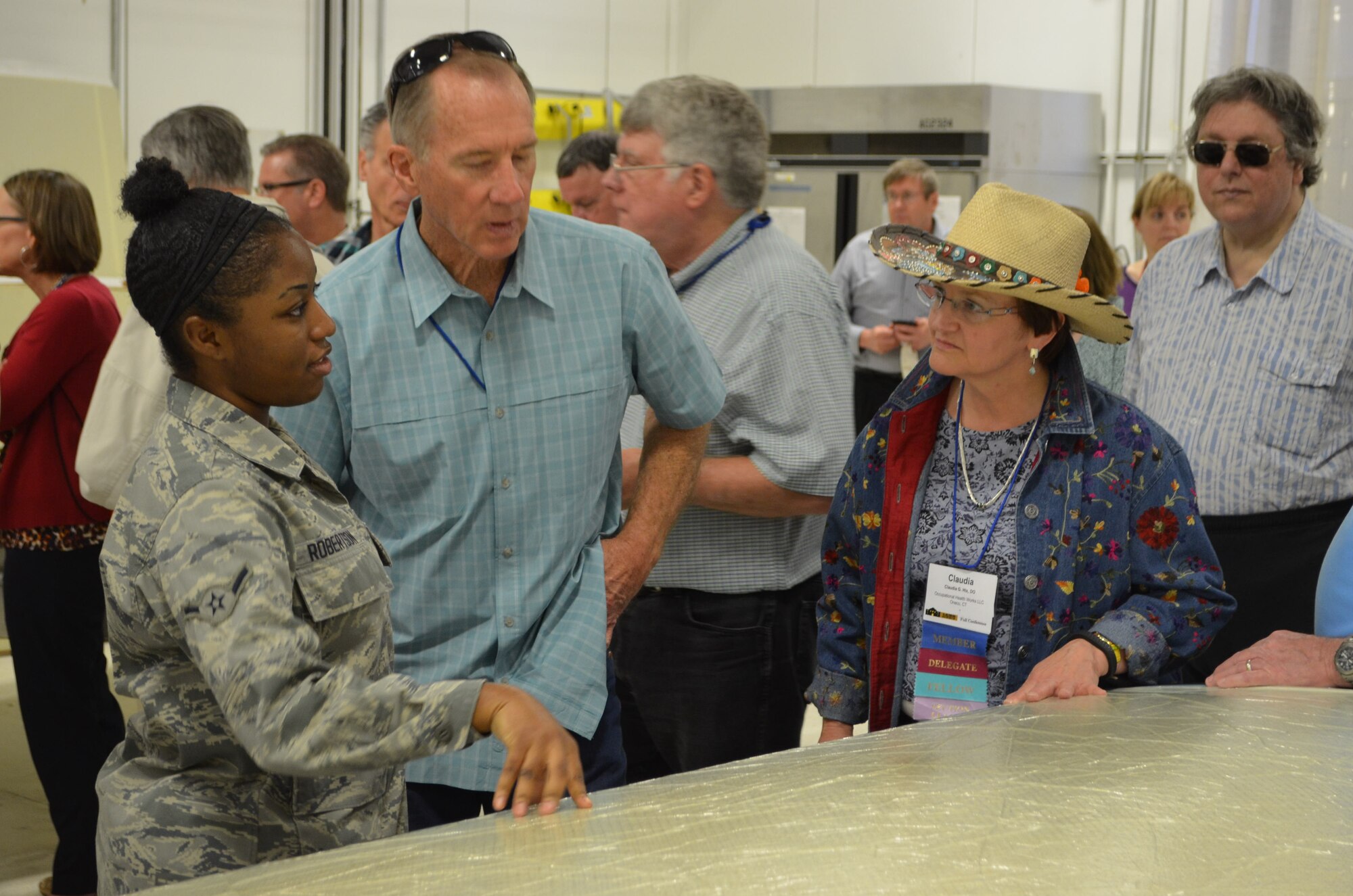 Airman Kiyara Robertson, aircraft structural maintenance technician, 433rd Maintenance Squadron, in the composite bonding shop, April 29, 2014 at Joint Base San Antonio-Lackland, Texas explains to group of occupational medicine physicians, how maintainers use vacuum molds to create the contour molded interior trim panels for the C-5A Galaxy aircraft. (U.S. Air Force photo/Senior Master Sgt. Minnie Jones)

