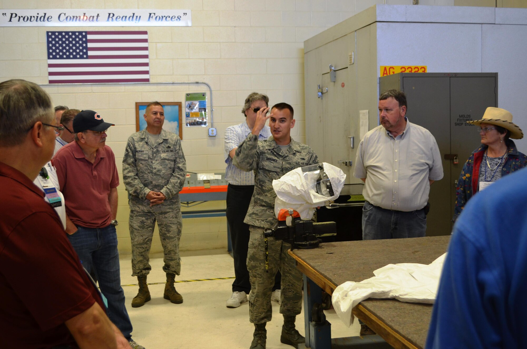 Senior Airmen Kenan Torrance, aircraft structural maintenance technician,433rd Maintenance Squadron, demonstrates protective equipment used in the corrosion control shop such as the positive pressure breathing hood on April 29, 2014 at Joint Base San Antonio-Lackland, Texas. Occupational medicine physicians were given a tour of the corrosion control facility and the special safety and hazardous challenges that the aircraft poses for aircraft maintainers.  (U.S. Air Force photo/Senior Master Sgt. Minnie Jones)