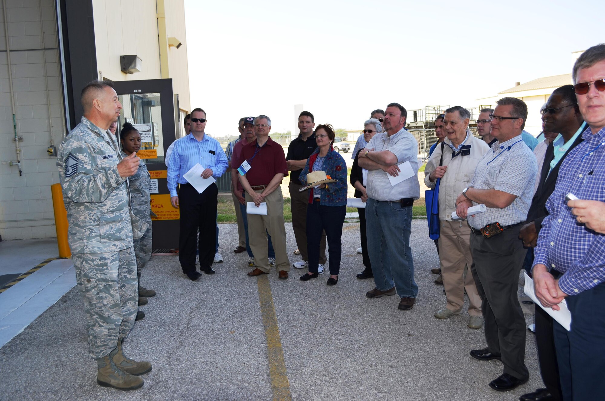 Senior Master Sgt. Alberto Saldivar, supervisor, corrosion control, 433rd Maintenance Squadron, Joint Base San Antonio-Lackland, Texas briefs occupational medicine physicians of American College of Occupational and Environmental Medicine, April 29, 2014, just prior to entering the corrosion control facility. Physicians got a firsthand look of the massive C-5A Galaxy aircraft and the special safety and hazardous challenges that the aircraft poses for aircraft maintainers, specifically corrosion control technicians.  (U.S. Air Force photo/Senior Master Sgt. Minnie Jones)