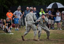Soldiers from the 6th Ranger Training Battalion perform hand-to-hand combat maneuvers during a demonstration at the Rangers’ Open House event May 10 at Eglin Air Force Base, Fla.  The event was a chance for the public to learn how Rangers train and operate. The event displays showed equipment, weapons, a reptile zoo, face painting and weapon firing among others. The demonstrations showed off hand-to-hand combat, a parachute jump, snake show, and Rangers in action.  (U.S. Air Force photo/Tech. Sgt. Sam King)