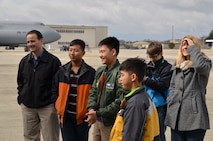 Family members surround Isaac Eun Soo French, Pilot for A Day, on Westover's flightline during a tour of the C-5 Galaxy during the April A UTA. Isaac was born in South Korea and adopted by the French family when he was three years old. He was born without portions of bones in his lower legs and middle fingers. (photo by TSgt. Brian Boynton)