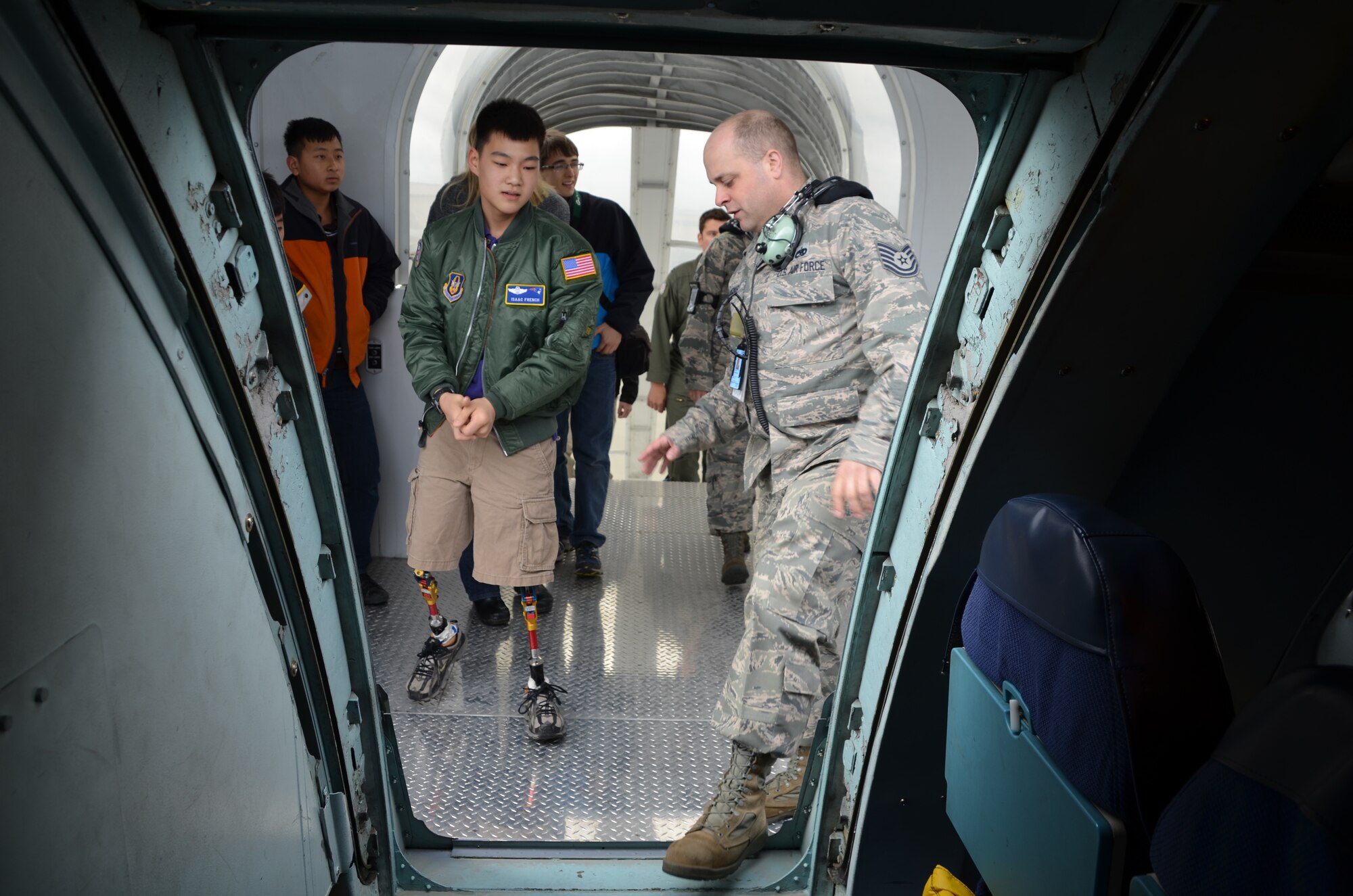 TSgt. Karl Koenig, 439th Maintenance Squadron, gives Isaac Eun Soo French, Pilot for A Day, a tour of the C-5 Galaxy during the April A UTA. Isaac was born in South Korea and adopted by the French family when he was three years old. He was born without portions of bones in his lower legs and middle fingers. (photo by TSgt. Brian Boynton)