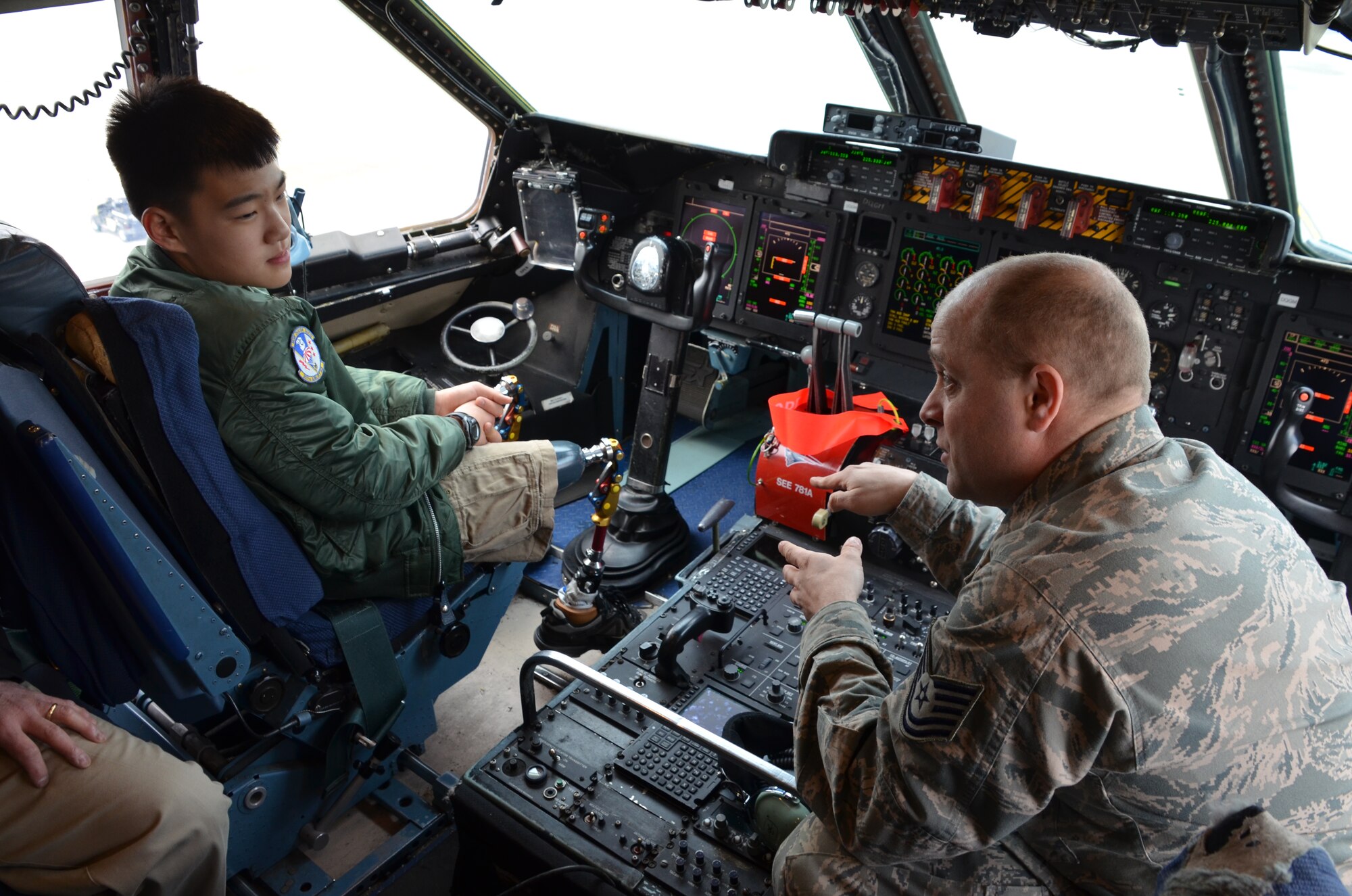TSgt. Karl Koenig, 439th Maintenance Squadron, explains C-5 maintenance
and flight controls to Isaac Eun Soo French, Pilot for A Day on the
April A UTA. (photo by TSgt. Brian Boynton)