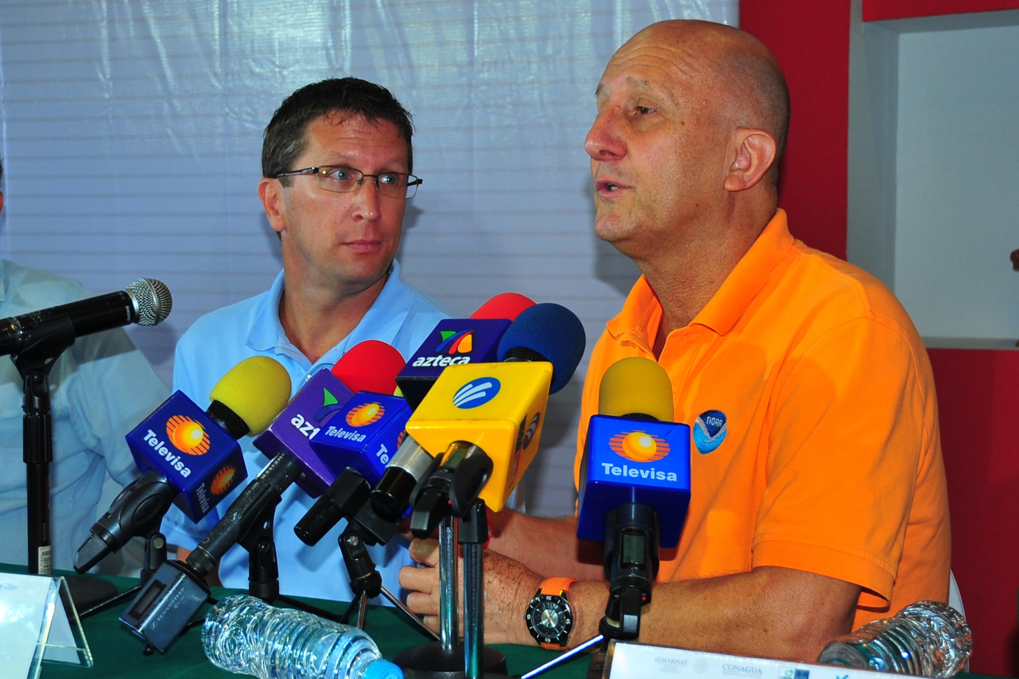 Dr. Lixion Avila, National Hurricane Center senior hurricane specialist, translates for Dr. Richard Knaab, NHC director, during a press conference at Manzanillo International Airport, Mexico, May 5, 2014, during the Caribbean Hurricane Awareness Tour. At each CHAT location, Knabb and representatives
from the countries' meteorological services and disaster preparedness agencies briefed local officials and the media about the impact of hurricanes in the region and the importance of being prepared. The CHAT, an outreach program, a joint effort between National Oceanic and Atmospheric Administration's National Hurricane Center and the 403rd Wing's 53rd Weather Reconnaissance Squadron, promotes hurricane awareness and preparedness throughout the Caribbean region. (U.S. Air Force photo/Maj. Marnee A.C.
Losurdo)
