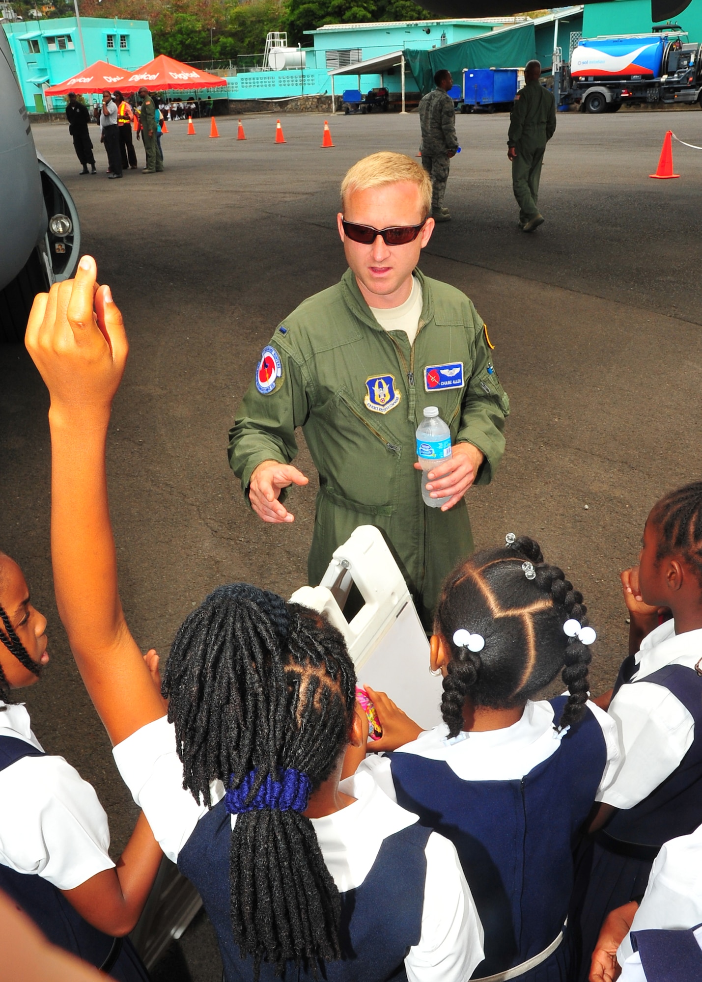 1st Lt. Chase Capt. Allen, 53rd Weather Reconnaissance Squadron pilot, answers student's questions during a tour of the WC-130J at the E.T. Joshua Airport, St. Vincent, May 9, 2014 during the Caribbean Hurricane Awareness Tour May 4-11, 2014. More than 700 locals toured the WC-130J, which was on display as part of the CHAT. The outreach program, which began in the 1970's and is a joint effort between National Oceanic and Atmospheric Administration's National Hurricane Center and the 403rd Wing's 53rd Weather Reconnaissance Squadron, promotes hurricane awareness and preparedness throughout the Caribbean region. (U.S. Air Force photo/Maj. Marnee A.C. Losurdo)
