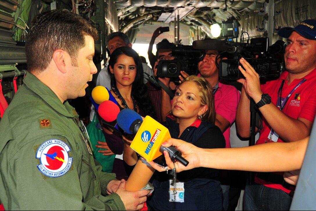 Mexican media interview Maj. Rafael Salort, 53rd Weather Reconnaissance Squadron navigator, at Manzanillo International Airport, Mexico, May 5, 2014, during the Caribbean Hurricane Awareness Tour. More than 1,300 locals toured the WC-130J, which was on display as part of the CHAT. The outreach program, which began in the 1970's and is a joint effort between National Oceanic and Atmospheric Administration's National Hurricane Center and the 403rd Wing's 53rd Weather Reconnaissance Squadron, promotes hurricane awareness and preparedness throughout the Caribbean region. (U.S. Air Force photo/Maj. Marnee A.C. Losurdo)