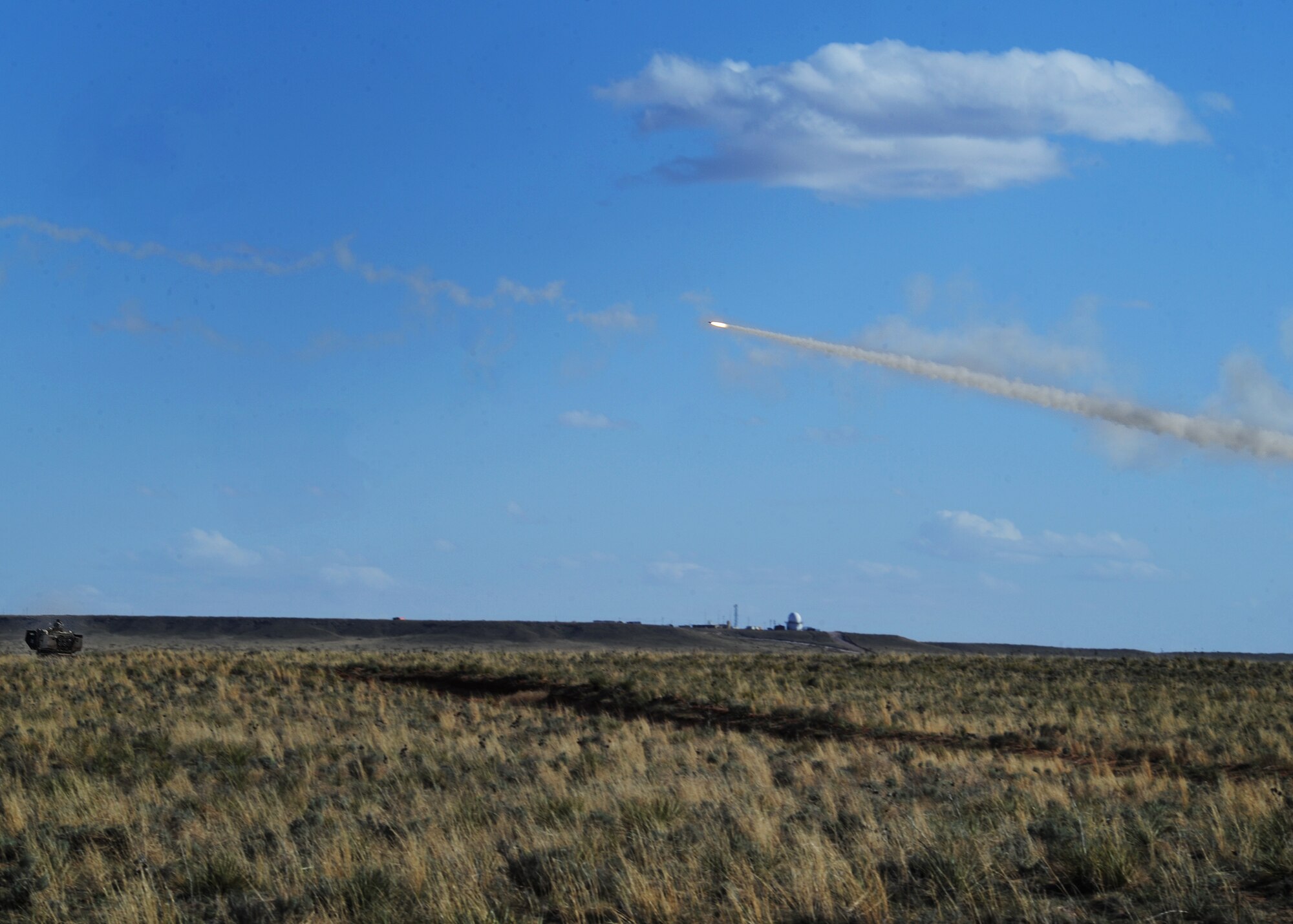 A rocket fires during High Mobility Artillery Rocket System training April 30, 2014 at Melrose Air Force Range, N.M. The training consisted of firing off 24 rockets that broke the sound barrier causing mild sonic booms. (U.S. Air Force photo/Senior Airman Ericka Engblom)