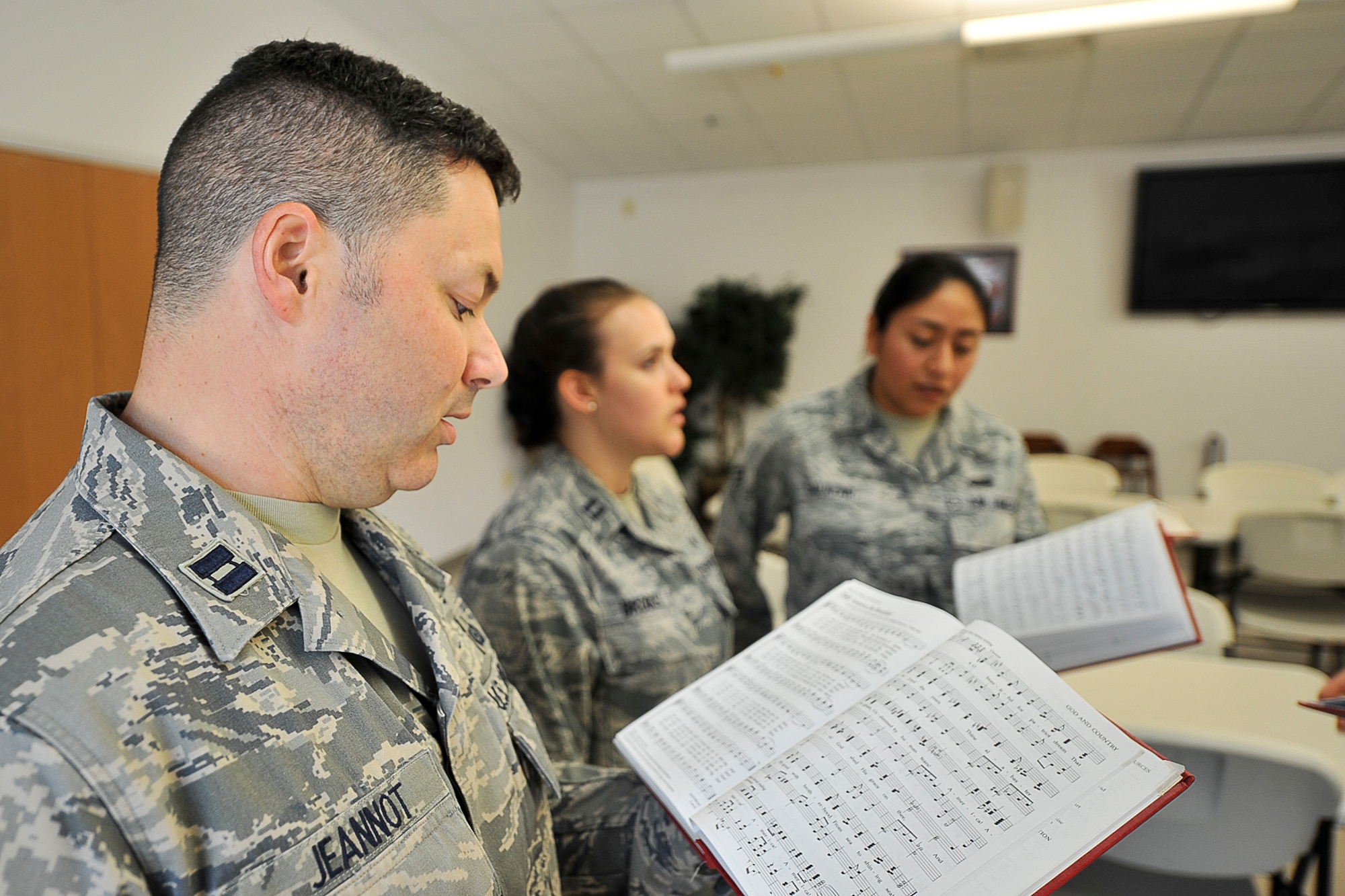 GOODFELLOW AIR FORCE BASE, Texas – Capt. Eric T. Jeannot, 315th Training Squadron instructor, Capt. Heather M. Brooks, 17th Medical Operations Squadron general dentist, and Senior Airman Rachel N. Salazar, 17th Communications Squadron commercial communications technician, sing America the Beautiful during Patriotic Blue practice at the Taylor Chapel here May 6. Patriotic Blue practices every Tuesday at 11:30 a.m. (U.S. Air Force photo/ Airman 1st Class Devin Boyer)