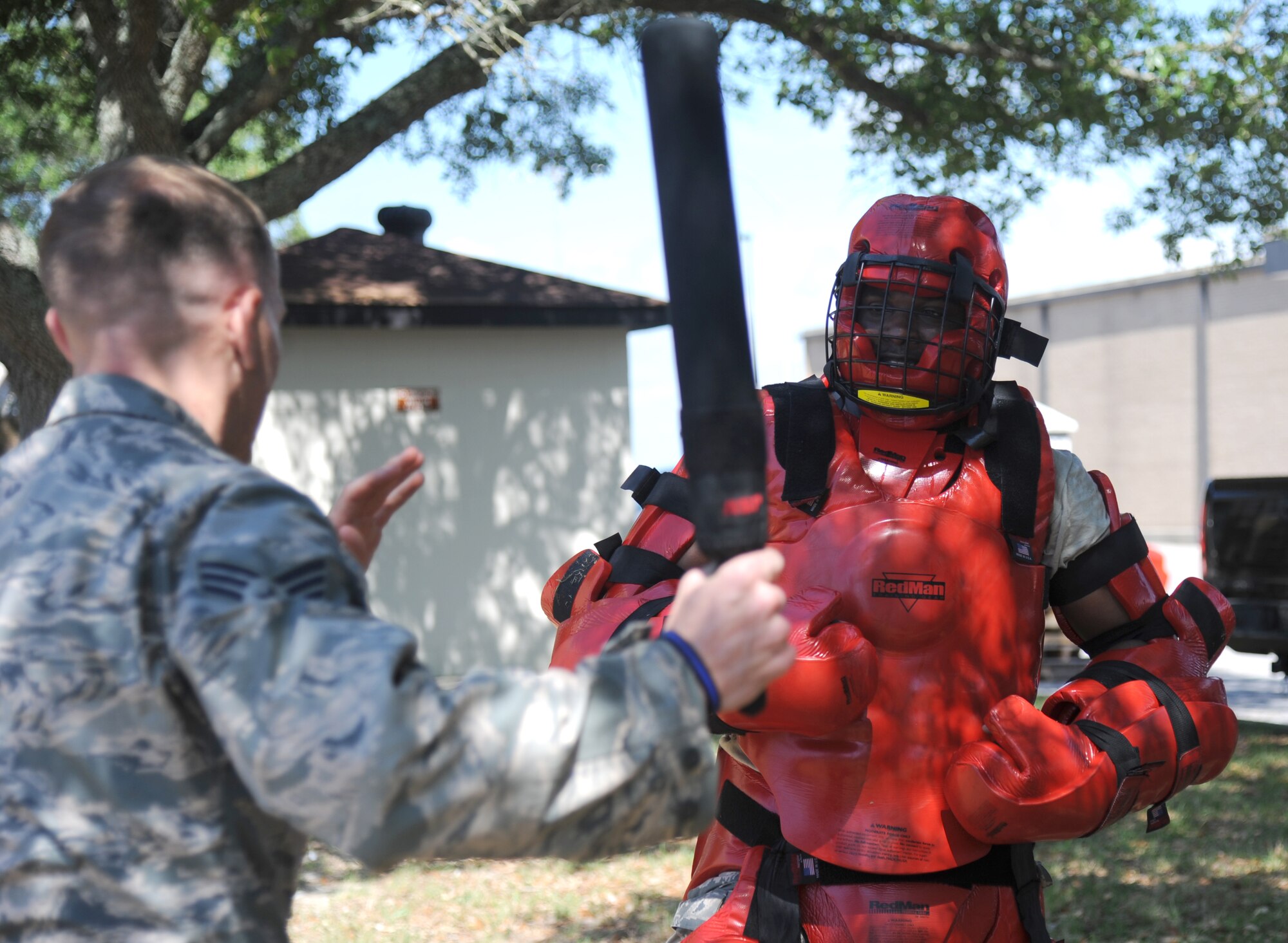 Senior Airmen Benton Sorrell and ReShaun Perry, 403rd Security Forces Reserve Unit, participate in less-than-lethal baton certification May 8, 2014, behind Wall Studio, Keesler Air Force Base, Miss.  This is a yearly certification required by all military and civilian law enforcement.  (U.S. Air Force photo by Kemberly Groue)