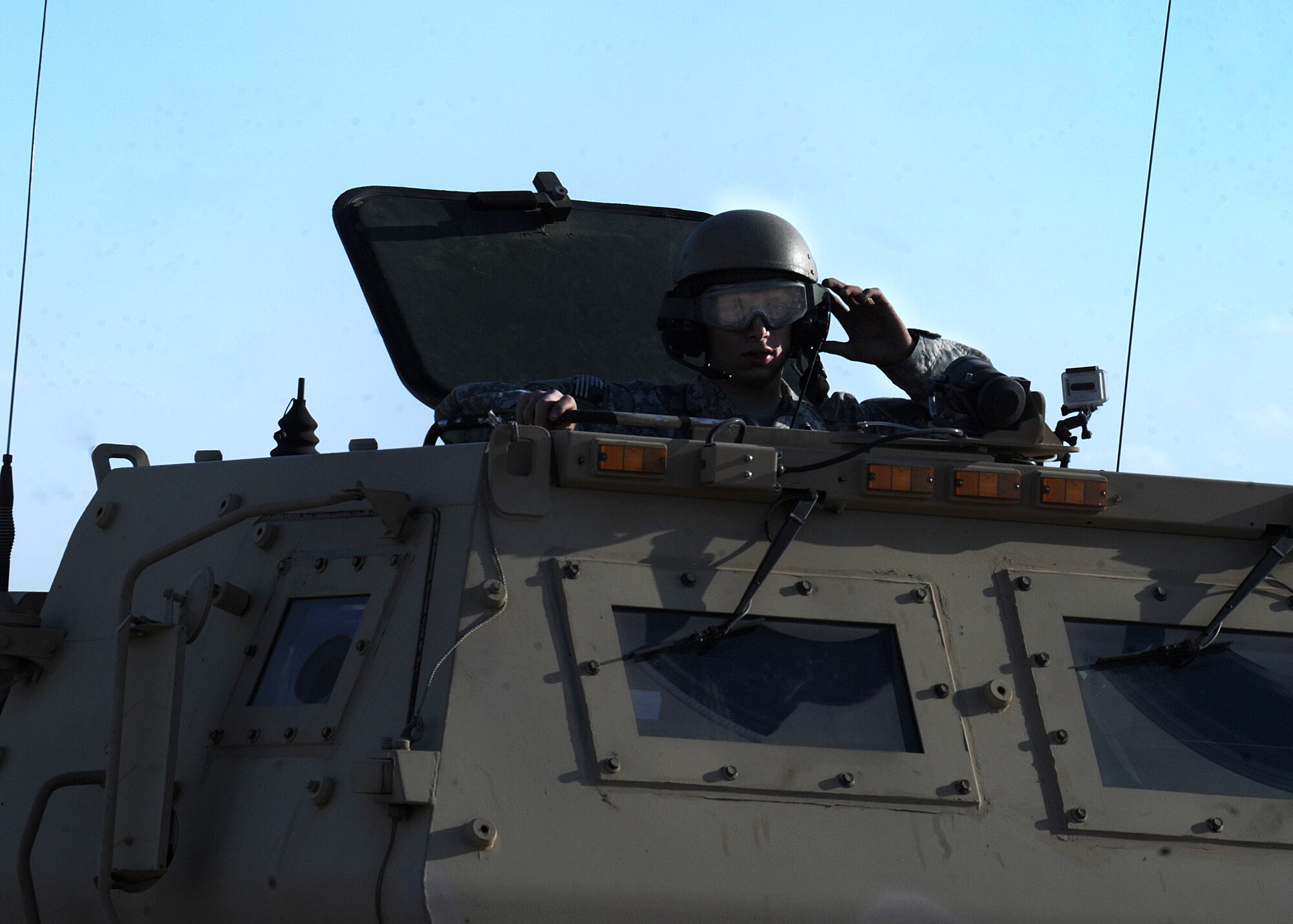 A U.S. Army member raises his protective goggles after firing for High Mobility Artillery Rocket System training April 30, 2014 at Melrose Air Force Range, N.M. The training consisted of firing off 24 rockets that broke the sound barrier causing mild sonic booms. (U.S. Air Force photo/Senior Airman Ericka Engblom)