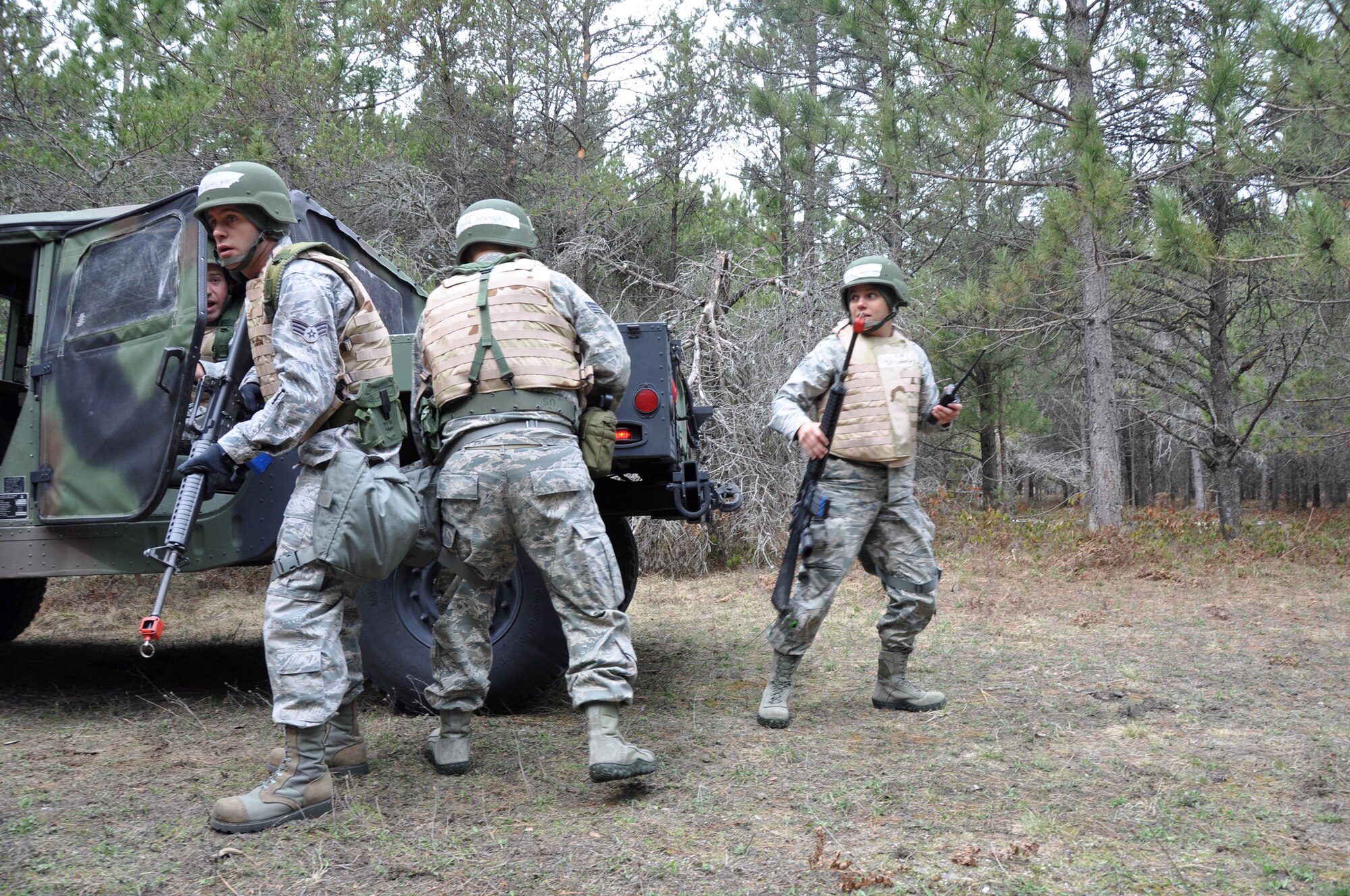 927 LRS members respond to small arms fire while stopped to pick up supplies during a convoy exercise. The vehicle operations specialists were tested on their knowledge and proficiency in small arms tactics and their ability to survive and operate in a deployed environment during the training exercise at Alpena CRTC May 5-9. (U.S. Air Force photo by Capt. Joe Simms)