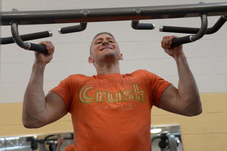 U.S. Air Force Staff Sgt. Nick Forester, 51st Maintenance Squadron tactical aircraft maintainer, assigned to Osan Air Base, South Korea, performs a pull-up at the 20th Force Support Squadron Shaw Fitness and Health Center on Shaw Air Force Base, S.C., May 12, 2014. Though Forester is on leave, he is determined to maintain a high fitness level in order to meet the Air Force standard. (U.S. Air Force photo by Airman 1st Class Michael A. Cossaboom/Released)