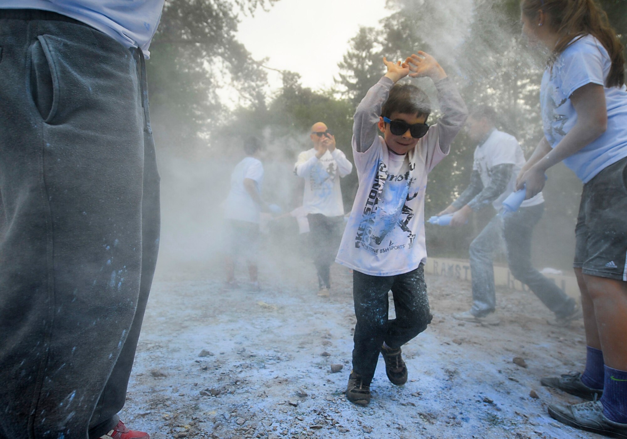 Members of Team Ramstein run through the final color station during the Keystone Color Run on Ramstein Air Base, Germany, May 10, 2014. More than 800 participants came out for the family 5K to raise awareness for teen suicide. Proceeds were donated to a program dedicated to providing support for youth and veterans experiencing risk factors for suicide. (U.S. Air Force photo/Staff Sgt. Sara Keller)
