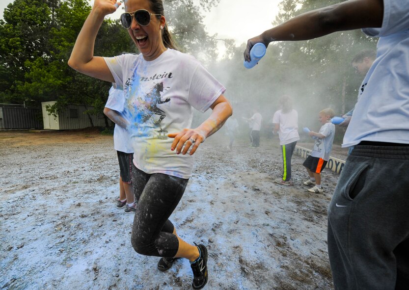 Members of Team Ramstein run through the final color station during the Keystone Color Run on Ramstein Air Base, Germany, May 10, 2014. More than 800 participants came out for the family 5K to raise awareness for teen suicide. Proceeds were donated to a program dedicated to providing support for youth and veterans experiencing risk factors for suicide. (U.S. Air Force photo/Staff Sgt. Sara Keller)