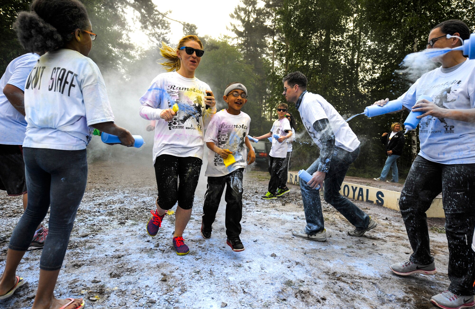 Members of Team Ramstein run through the final color station during the Keystone Color Run on Ramstein Air Base, Germany, May 10, 2014. More than 800 participants came out for the family 5K to raise awareness for teen suicide. Proceeds were donated to a program dedicated to providing support for youth and veterans experiencing risk factors for suicide. (U.S. Air Force photo/Staff Sgt. Sara Keller)