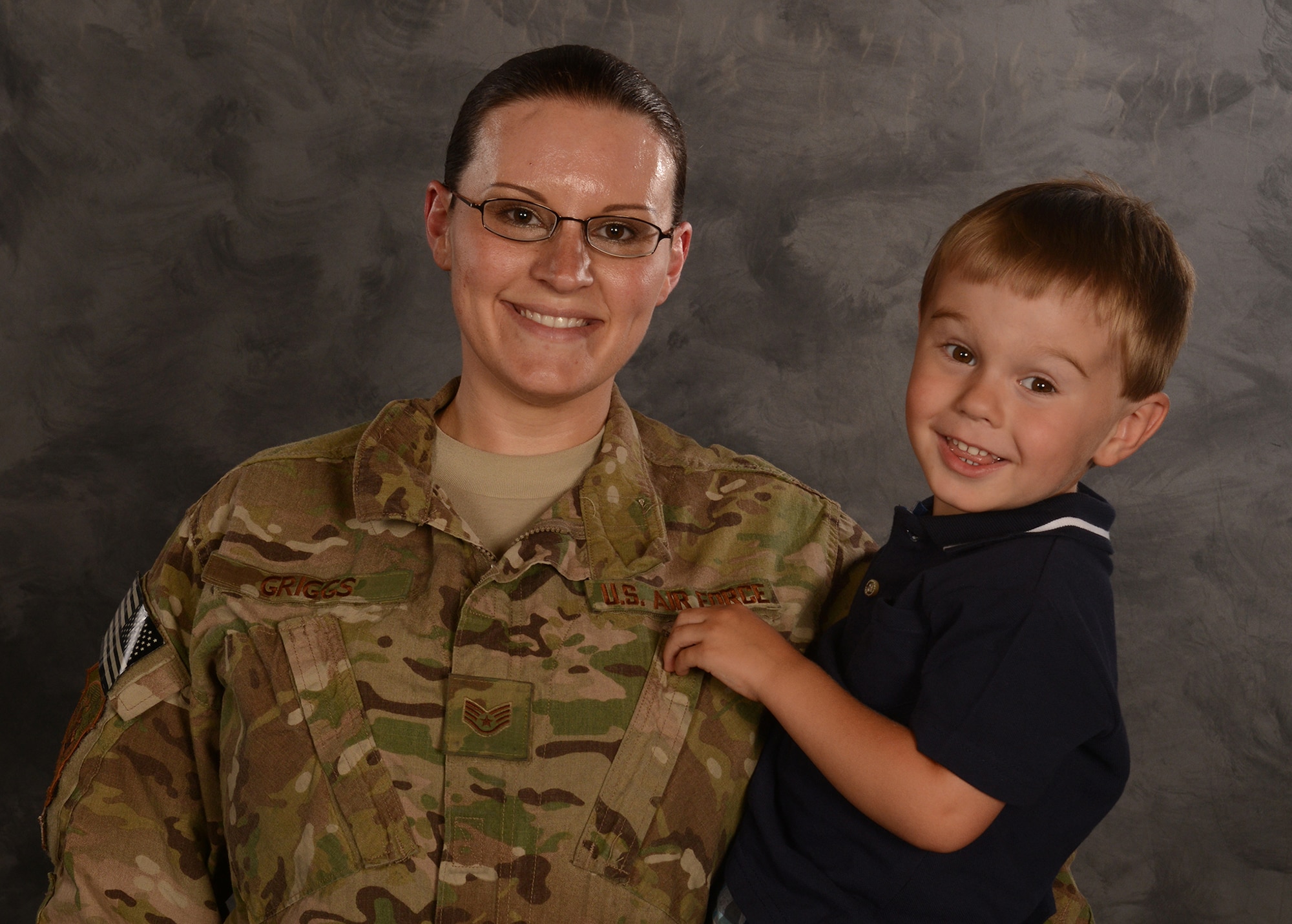 U.S. Air Force Staff Sgt. Amanda Griggs, 23d Component Maintenance Squadron aerospace propulsion craftsman, holds her son, Korbin, for a photo at Moody Air Force Base, Ga., May 8, 2014. Griggs was deployed to Bagram Air Field, Afghanistan for six months of Korbin’s life and was selected to share her story in honor of Mother’s Day 2014. (U.S. Air Force photo illustration by Senior Airman Tiffany M. Grigg/Released)
