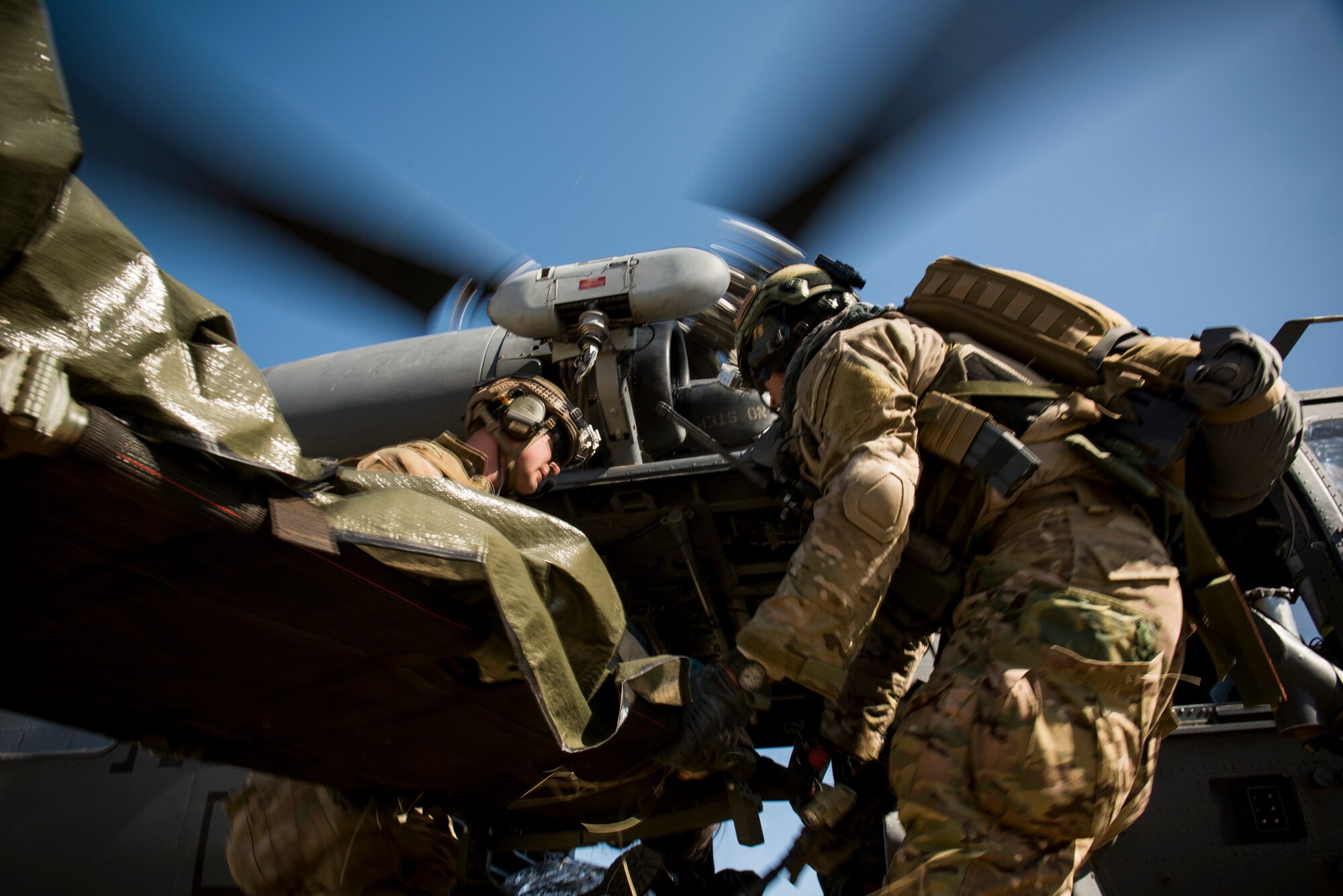 Pararescuemen from the 58th Rescue Squadron out of Nellis Air Force Base, Nev., transport an attack victim to a 41st Rescue Squadron HH-60G Pave Hawk out of Moody Air Force Base, Ga., during an Angel Thunder mass-casualty exercise May 9, 2014, at Camp Navajo, Ariz. Angel Thunder is an exercise that provides personnel recovery and combat search and rescue training for combat air crews, pararescue, intelligence personnel, battle managers, and joint search and rescue center personnel. (U.S. Air Force photo by Staff Sgt. Jamal D. Sutter/Released)  
