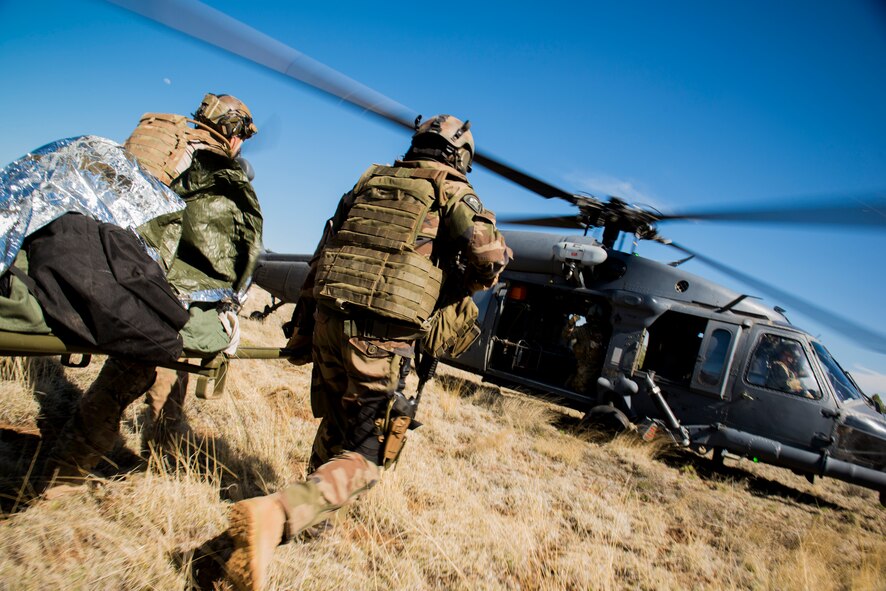 Pararescuemen from the 58th Rescue Squadron out of Nellis Air Force Base, Nev., transport a victim to a 41st Rescue Squadron HH-60G Pave Hawk out of Moody Air Force Base, Ga., during an Angel Thunder mass-casualty exercise May 9, 2014, at Camp Navajo, Ariz. Air Force ROTC cadets played the roles of victims during the scenario and received an up-close-and-personal view of the Air Force’s rescue mission. (U.S. Air Force photo by Staff Sgt. Jamal D. Sutter/Released) 
