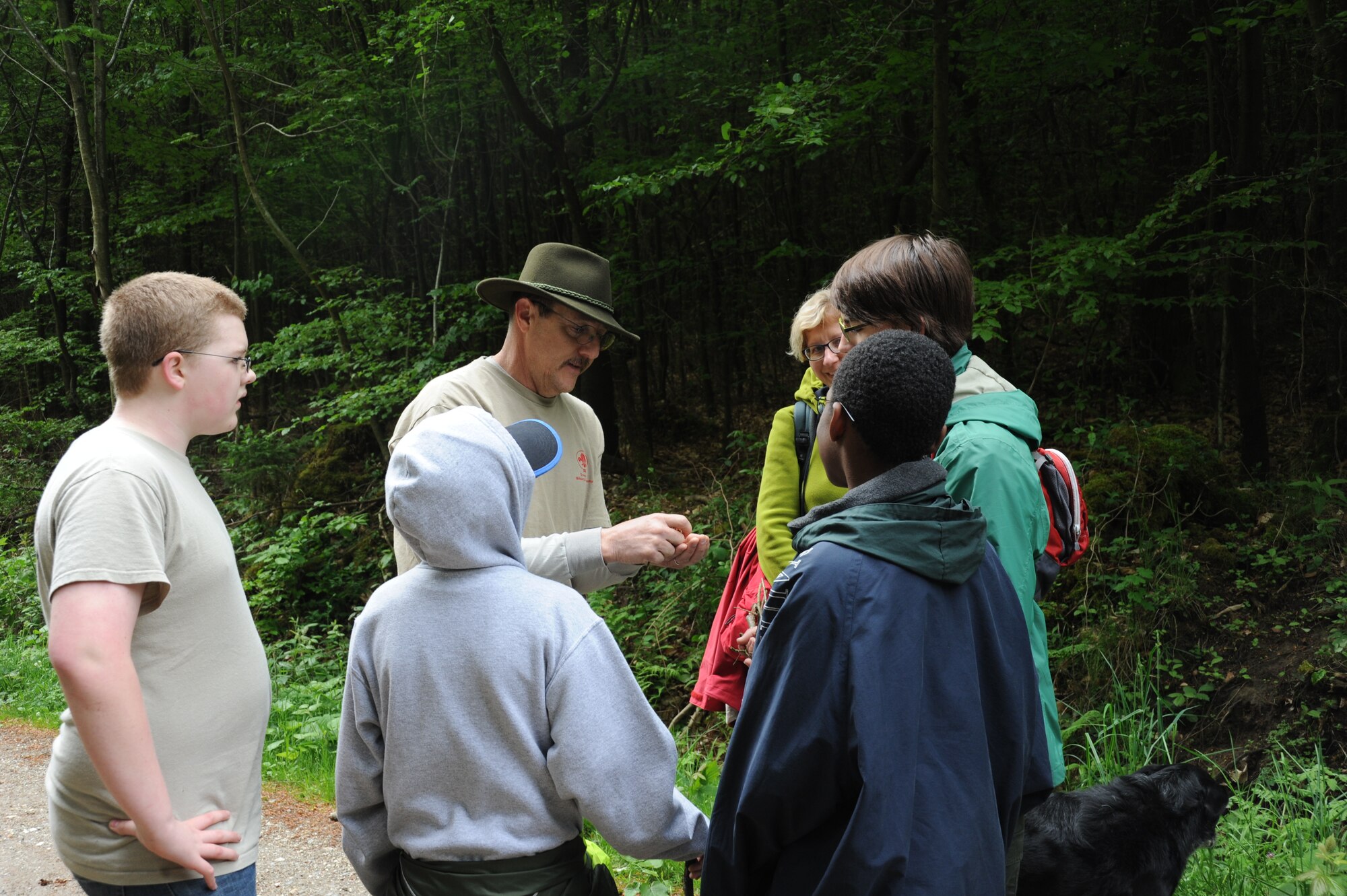 Jene Wilton, 606th Air Control Squadron Air Force engineering technical services and Boy Scouts Troop 161 assistant scout master, teaches scouts about what type of wood is the best to start a fire May 10, 2014, near Spangdahlem Air Base, Germany. Scouts trained in hiking and wilderness survival skills during a 10 mile stretch. (U.S. Air Force photo by Airman 1st Class Dylan Nuckolls/Released) 