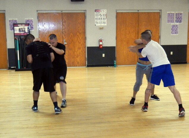 Participants practice Krav Maga techniques May 9, 2014, during a during a Krav Maga class at the Air Base Fitness and Sports Center at Joint Base Charleston, S.C. Classes are offered every Friday from noon till 1 p.m. through Sept. 26 as part of the Single Airman Initiative. SAI activities are primarily geared toward single Sailors and Airmen, ages 18-25, but all are welcome. (U.S. Air Force photo/Jessica Donnelly)
