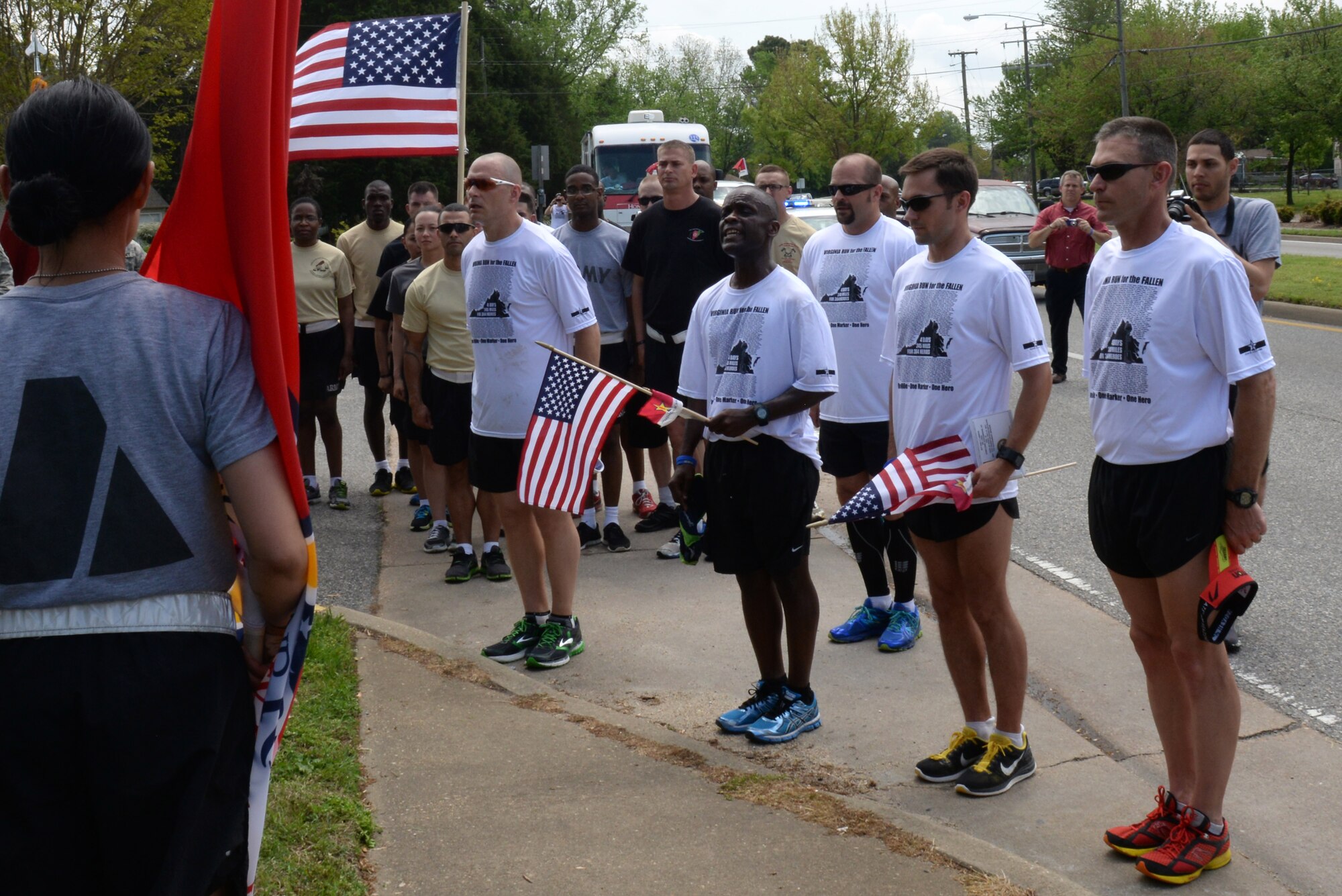 Hampton Roads community members stop at a “hero marker” to honor a fallen U.S. Service member during the Second Annual Run for the Fallen event in Hampton, Va., May 1, 2014. The Service members honored during this run were killed while supporting Operations Iraqi and Enduring Freedom. (U.S. Air Force photo by Senior Airman Teresa J.C. Aber/Released)