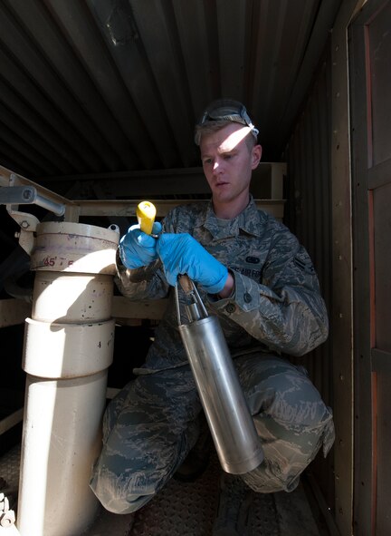 Airman 1st Class Jacob Brown, 5th Logistics Readiness Squadron fuels laboratory technician, tests fuel for contamination at Minot Air Force Base, N.D., April 30, 2014. The regular day of a fuels Airman is mostly comprised of off loading, inspecting and delivering the fuel to respective points on base. (U.S. Air Force photo/Senior Airman Andrew Crawford)