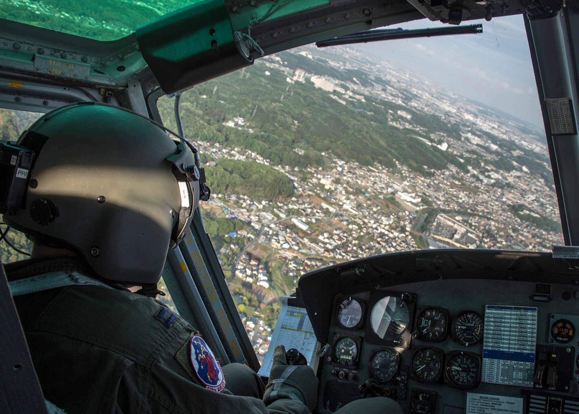 Capt. Jonathan Gentri, 459th Airlift Squadron pilot, banks during a turn in a UH-1N Huey as part of a formation training sortie May 8, 2014. Yokota Airmen regularly perform practice missions to be prepared to respond to any contingency.  (U.S Air Force photo by 2nd Lt. Ashley Wright/Released)