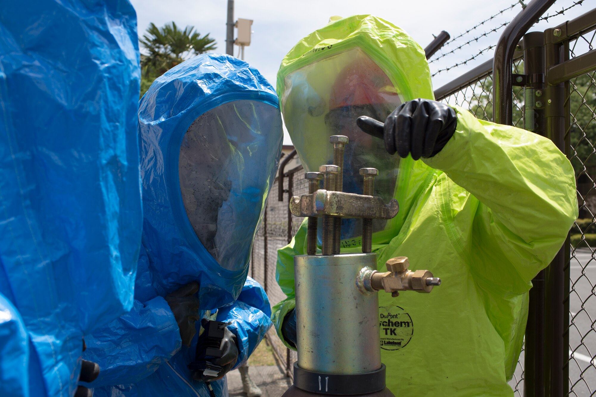 A team of emergency responders discuss the best approach to seal a gasket to a chlorine tank at Yokota Air Base, Japan, May 12, 2014. The scenario was part of an exercise to test Team Yokota’s response to chemical and hazardous material leaks. (U.S. Air Force photo by Osakabe Yasuo/Released)