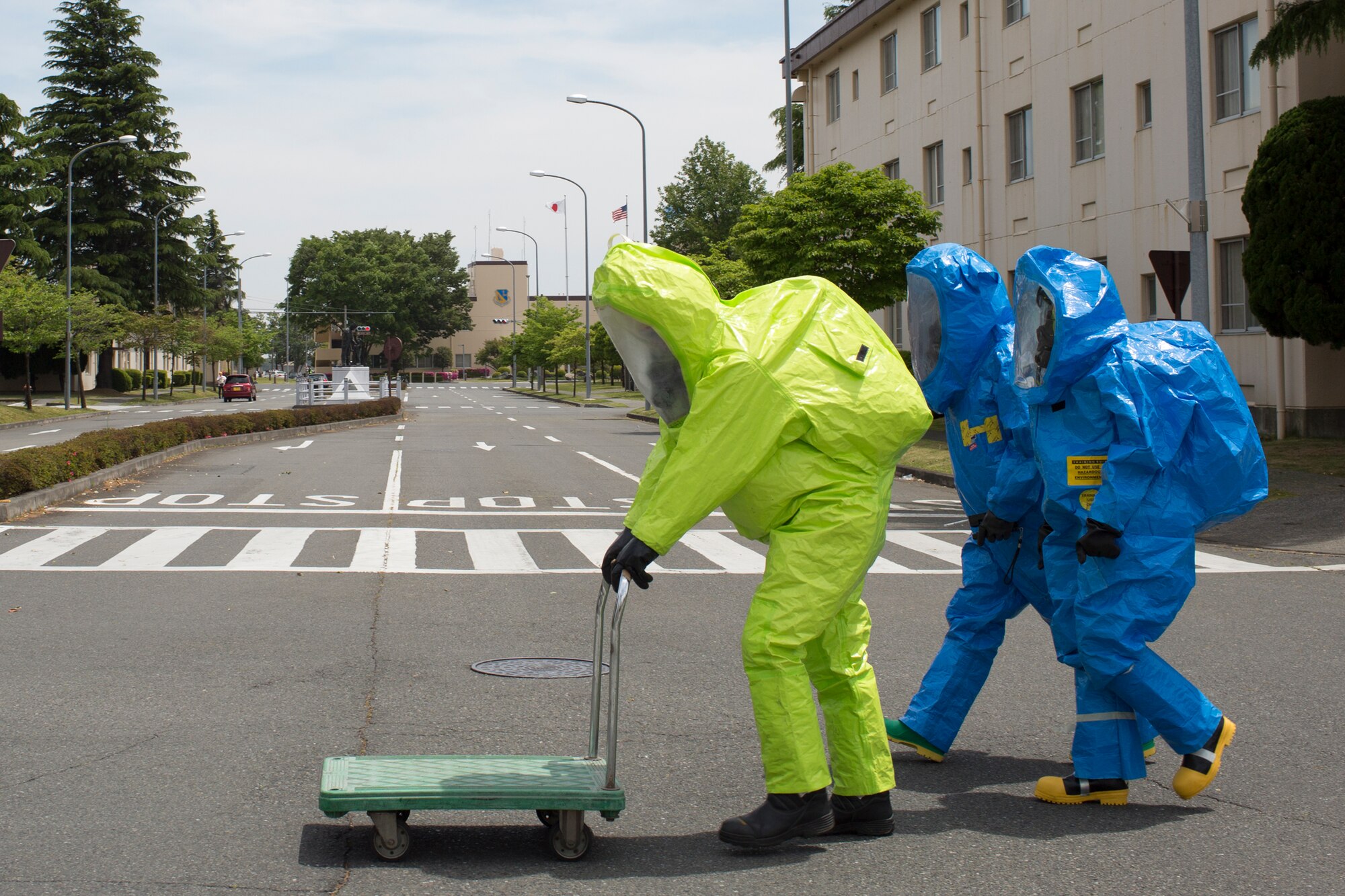 Emergency responders with the 374th Medical Operations Squadron bioenvironmental shop leave the scene of an exercise scenario at Yokota Air Base, Japan, May 12, 2014. The exercise consisted of a simulated chlorine leak and tested Yokota’s hazmat response capabilities. (U.S. Air Force photo by Osakabe Yasuo/Released)