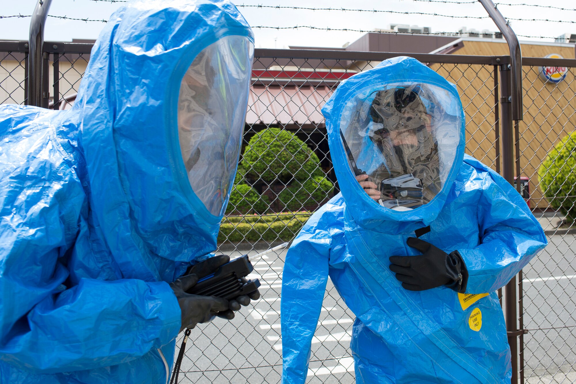 Members of the 374th Medical Operations Squadron bioenvironmental shop report their findings during a simulated chlorine gas leak at Yokota Air Base, Japan, May 12, 2014. The simulated scenario was part of an exercise to test Team Yokota’s chemical and hazardous material response actions. (U.S. Air Force photo by Osakabe Yasuo/Released)