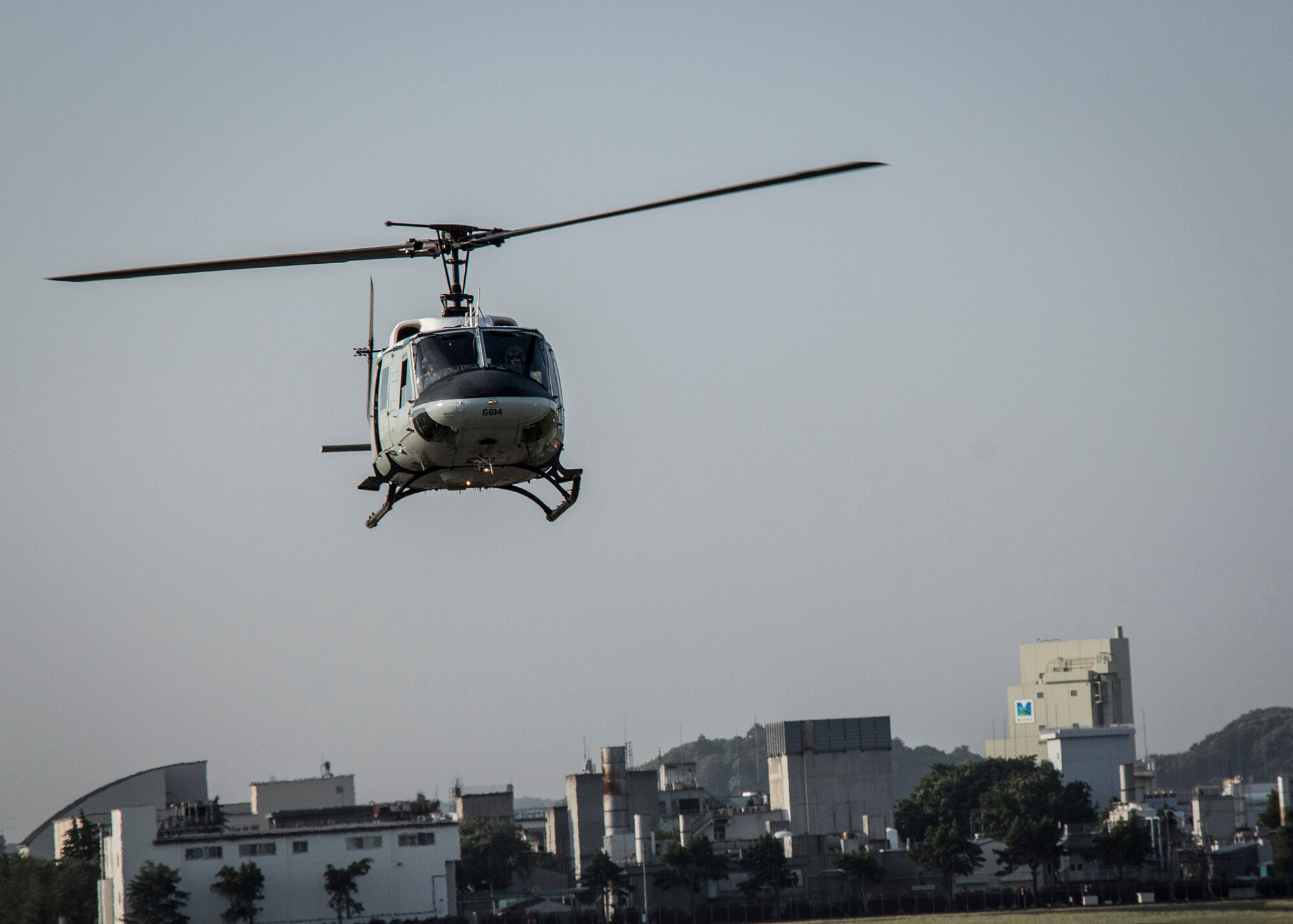 A UH-1N Huey with the 459th Airlift Squadron flies over the city of Fussa, in the Kanto Plains area, Japan, May 8, 2014.  Yokota Airmen regularly perform practice missions to be prepared to respond to any contingency.  (U.S Air Force photo by 2nd Lt. Ashley Wright/Released)