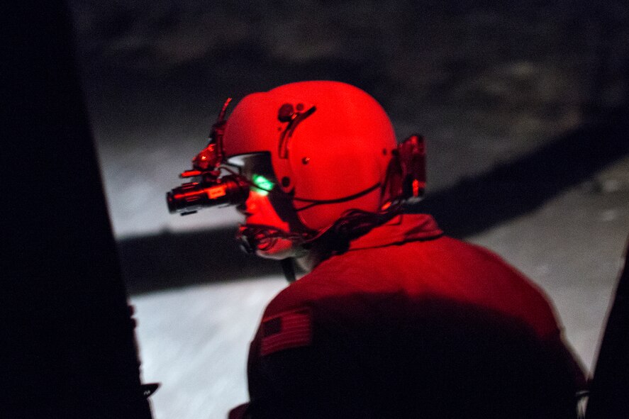 Tech. Sgt. Christopher Baker, 374th Operations Group, visually scans an area with night vision goggle from UH-1N Huey at Combined Arms training Center Camp Fuji, Japan, May 7, 2014. Airmen from the 459 AS conduct night vision goggle training in order to maintain proficiency with their equipment. (U.S. Air Force photo by Osakabe Yasuo/Released) 