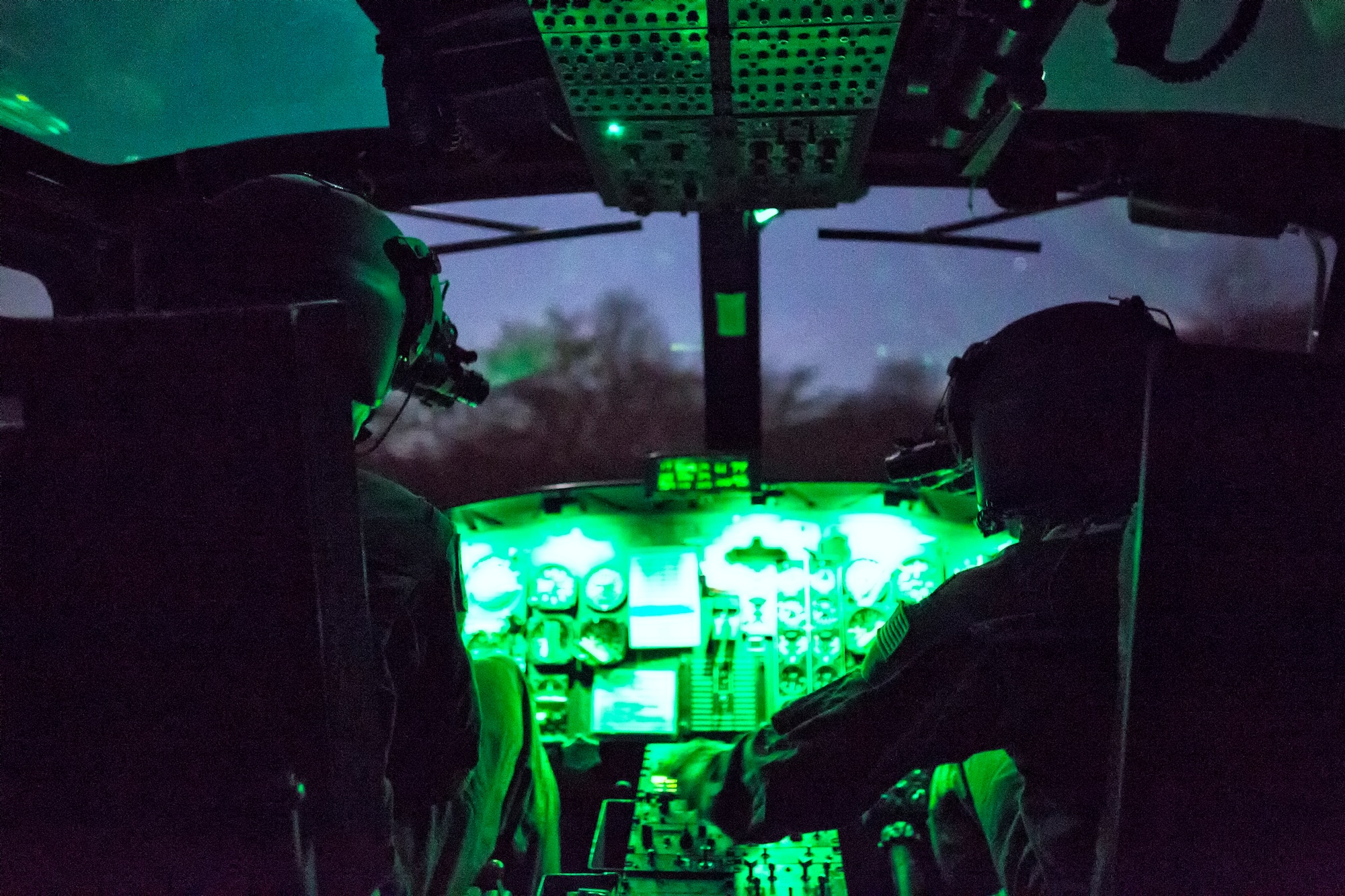 (Right to left) Maj. TJ Martin and 1st Lt. Jonathan Palka, both from the 459th Airlift Squadron UH-1N Huey helicopter pilot, take off a landing zone at Combined Arms Training Center Camp Fuji, Japan, May 7, 2014. Airmen from the 459 AS conduct night vision goggle training in order to maintain proficiency with their equipment. (U.S. Air Force photo by Osakabe Yasuo/Released) 