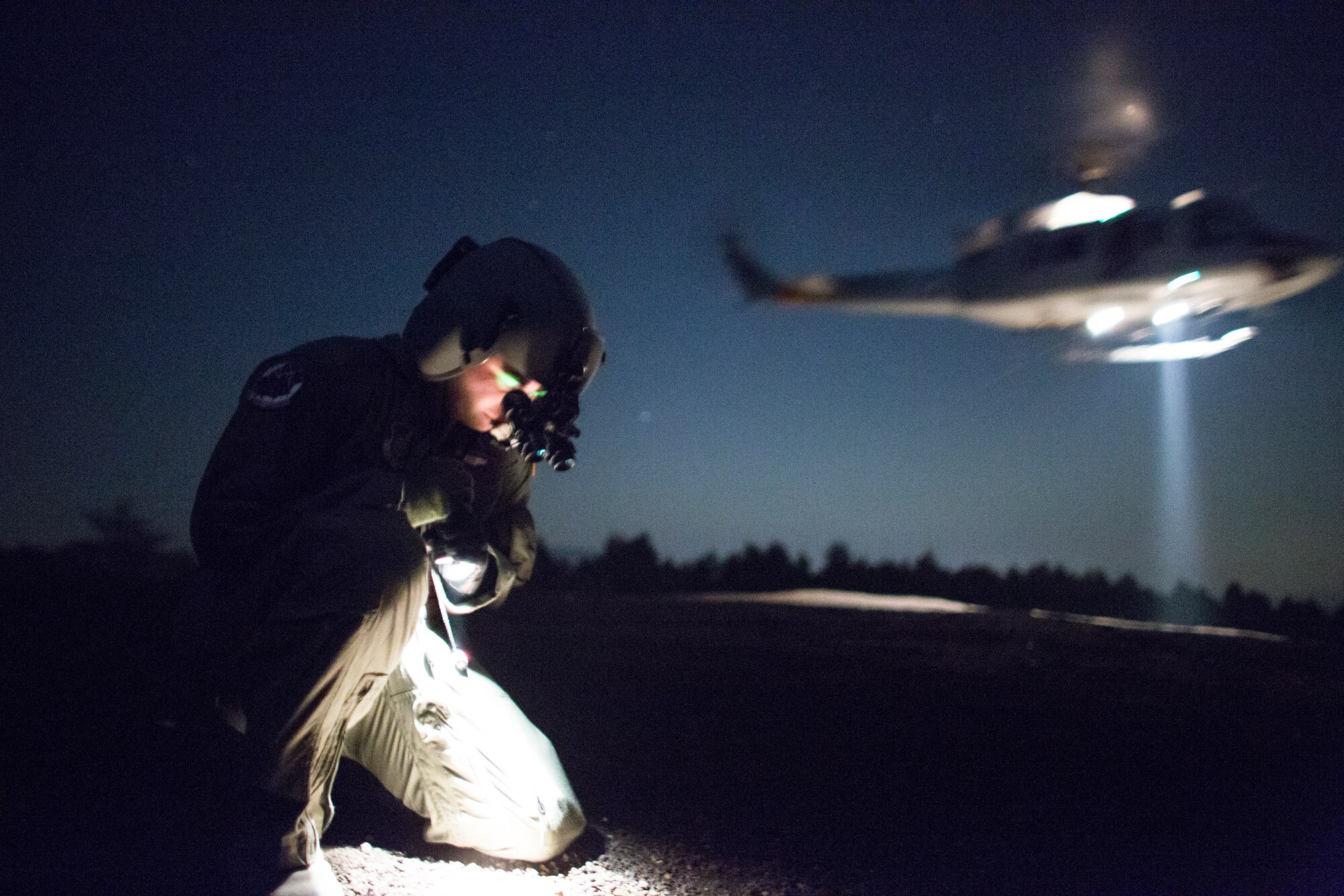 Staff Sgt. Christopher Rector, 459th Airlift Squadron flight engineer, performs a simulated UH-1N egress training at Combined Arms Training Center Camp Fuji, Japan, May 7, 2014. Airmen from the 459 AS conduct night vision goggle training in order to maintain proficiency with their equipment. (U.S. Air Force photo by Osakabe Yasuo/Released) 