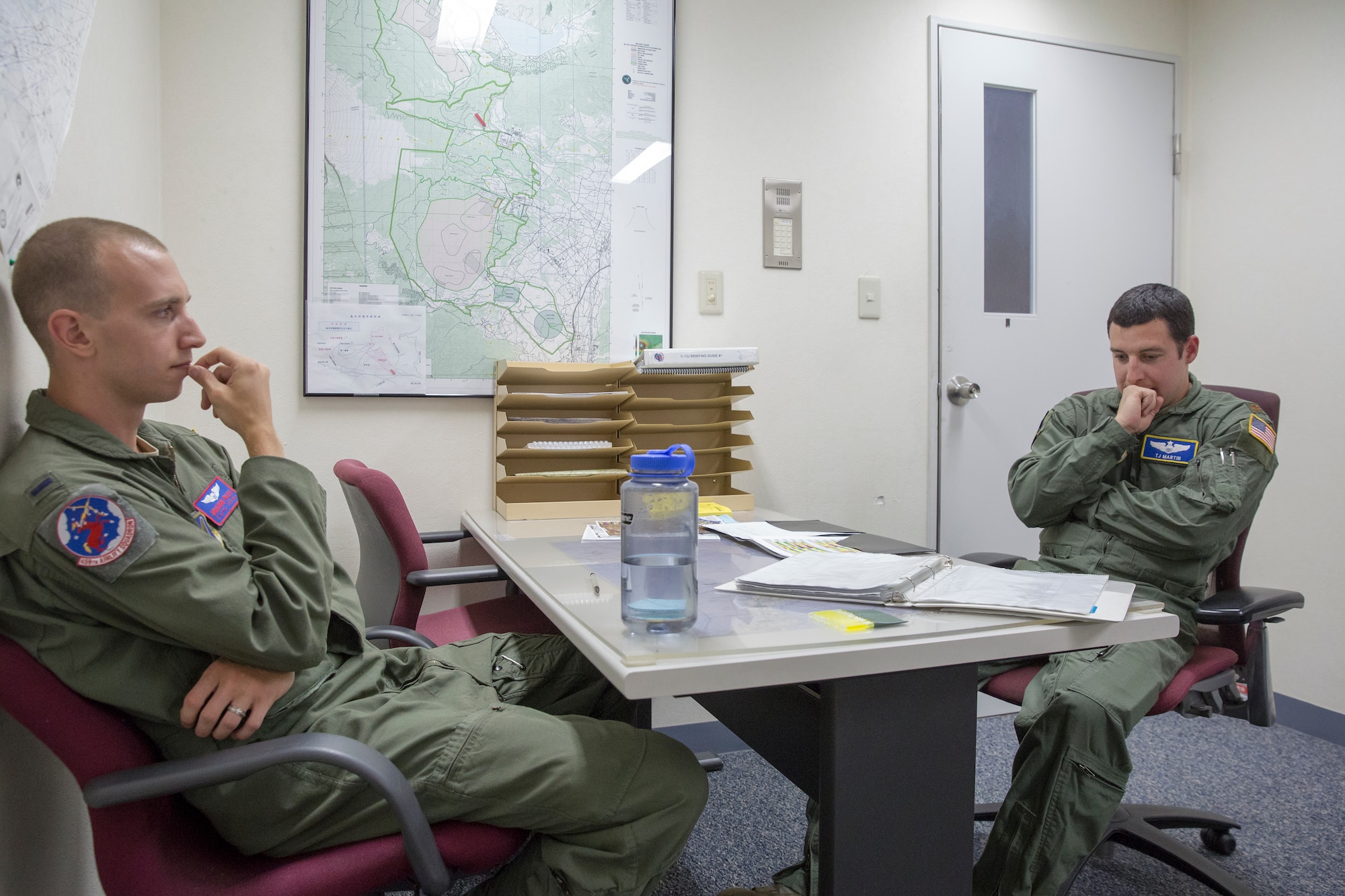 (Left to right) 1st Lt. Jonathan Palka and Maj. TJ Martin, both UH-1N Huey pilots from the 459th Airlift Squadron, conduct a pre-flight briefing at Yokota Air Base, Japan, May 7, 2014. Prior to each flight, the crew reviews their flight plan to make sure everyone is prepared for the flight. (U.S. Air Force photo by Osakabe Yasuo/Released)